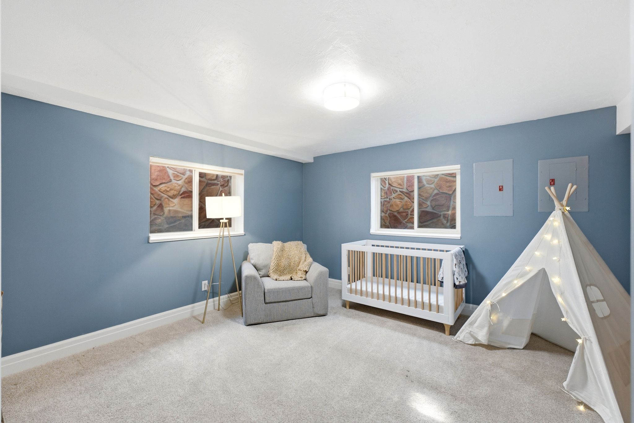 Carpeted room with blue walls and white trim