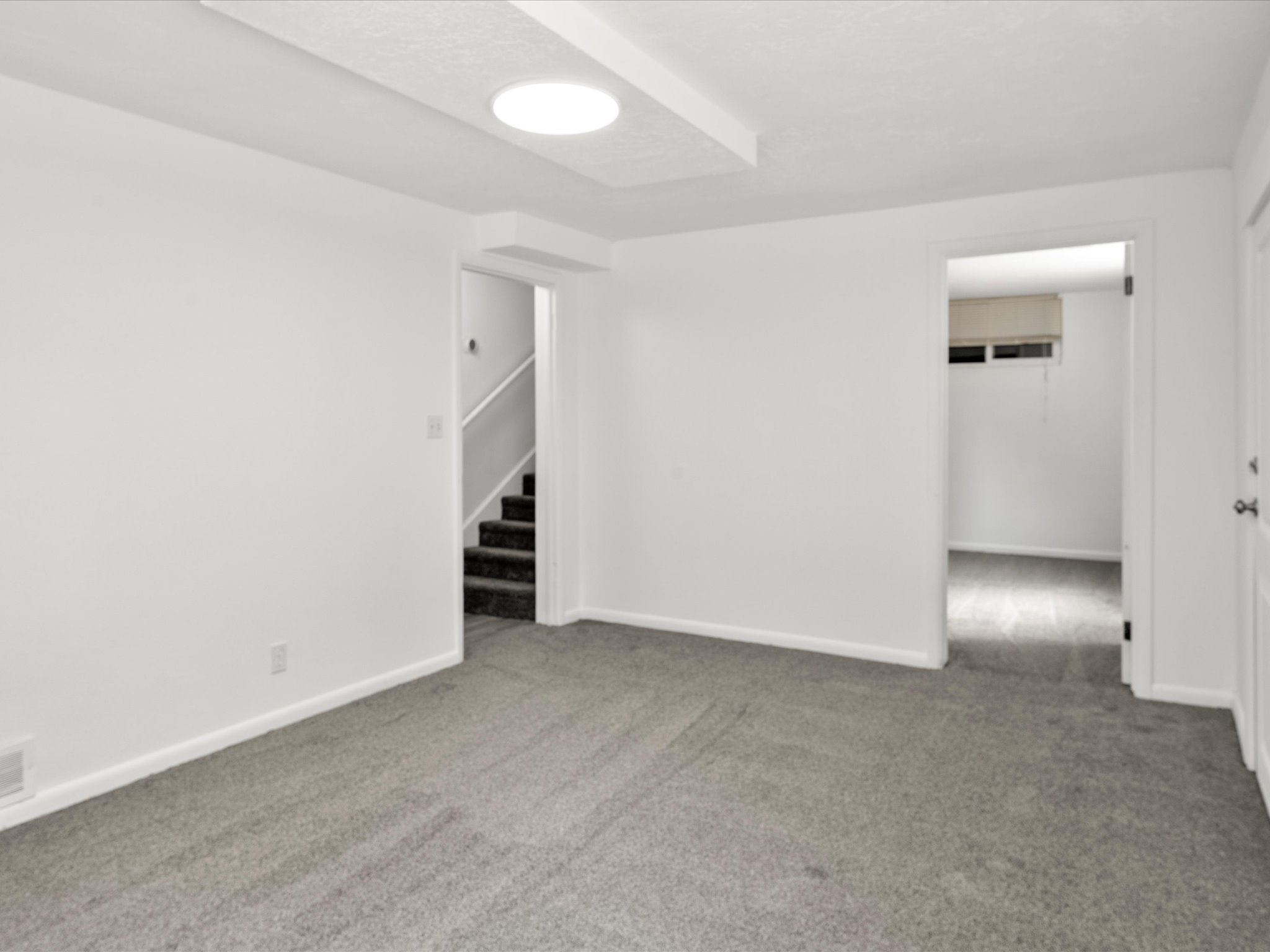 Room featuring neutral gray carpeting and white painted walls