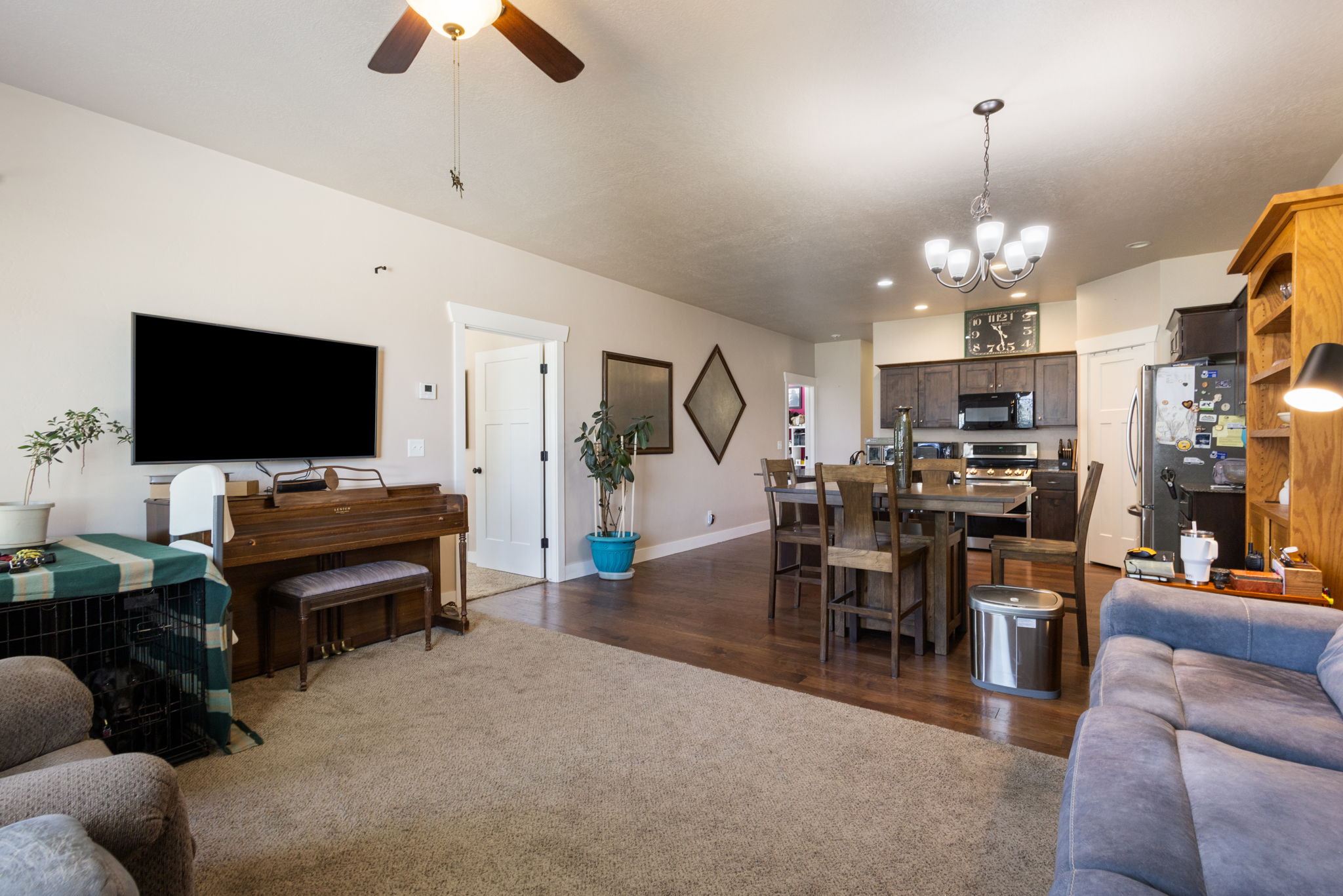 Open-concept living space with a ceiling fan light fixture