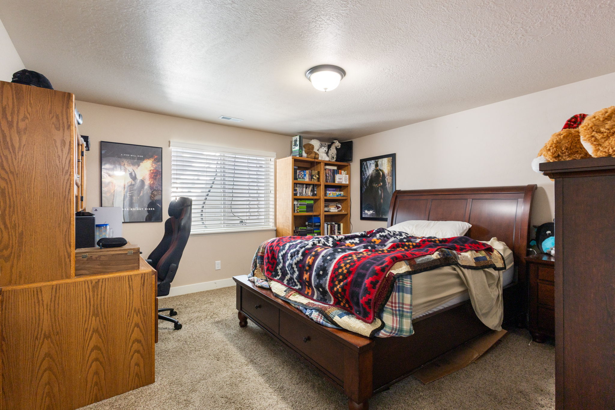 Carpeted bedroom with a window featuring blinds