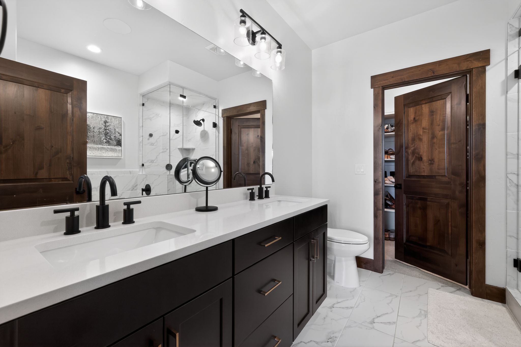 Dual vanity featuring a white countertop with integrated sinks and matte black hardware