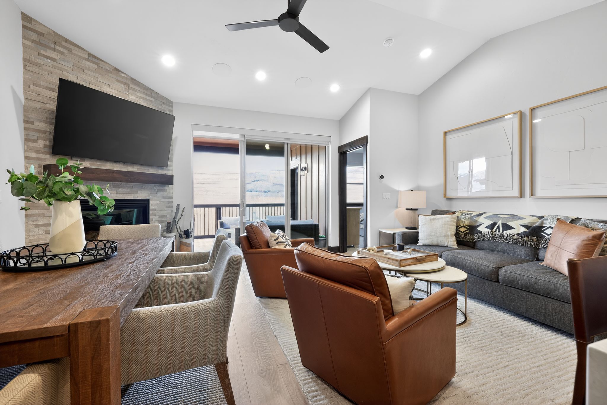 Open-concept living area with a vaulted ceiling, recessed lighting, and a modern ceiling fan
