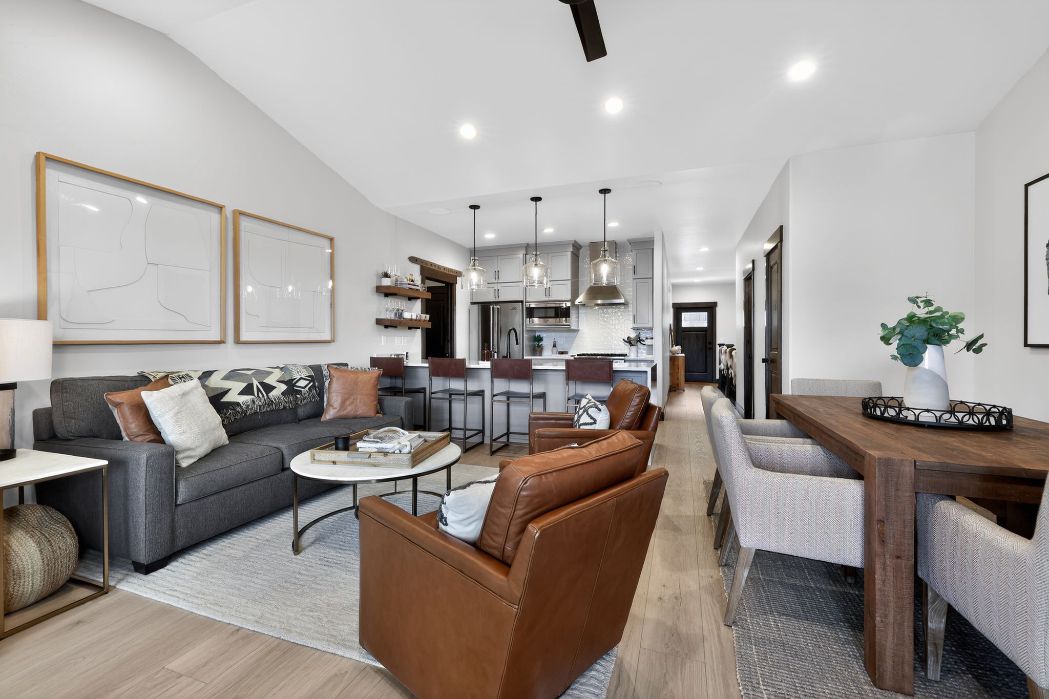 Vaulted ceiling in the living area, featuring recessed lighting and wood-finish flooring
