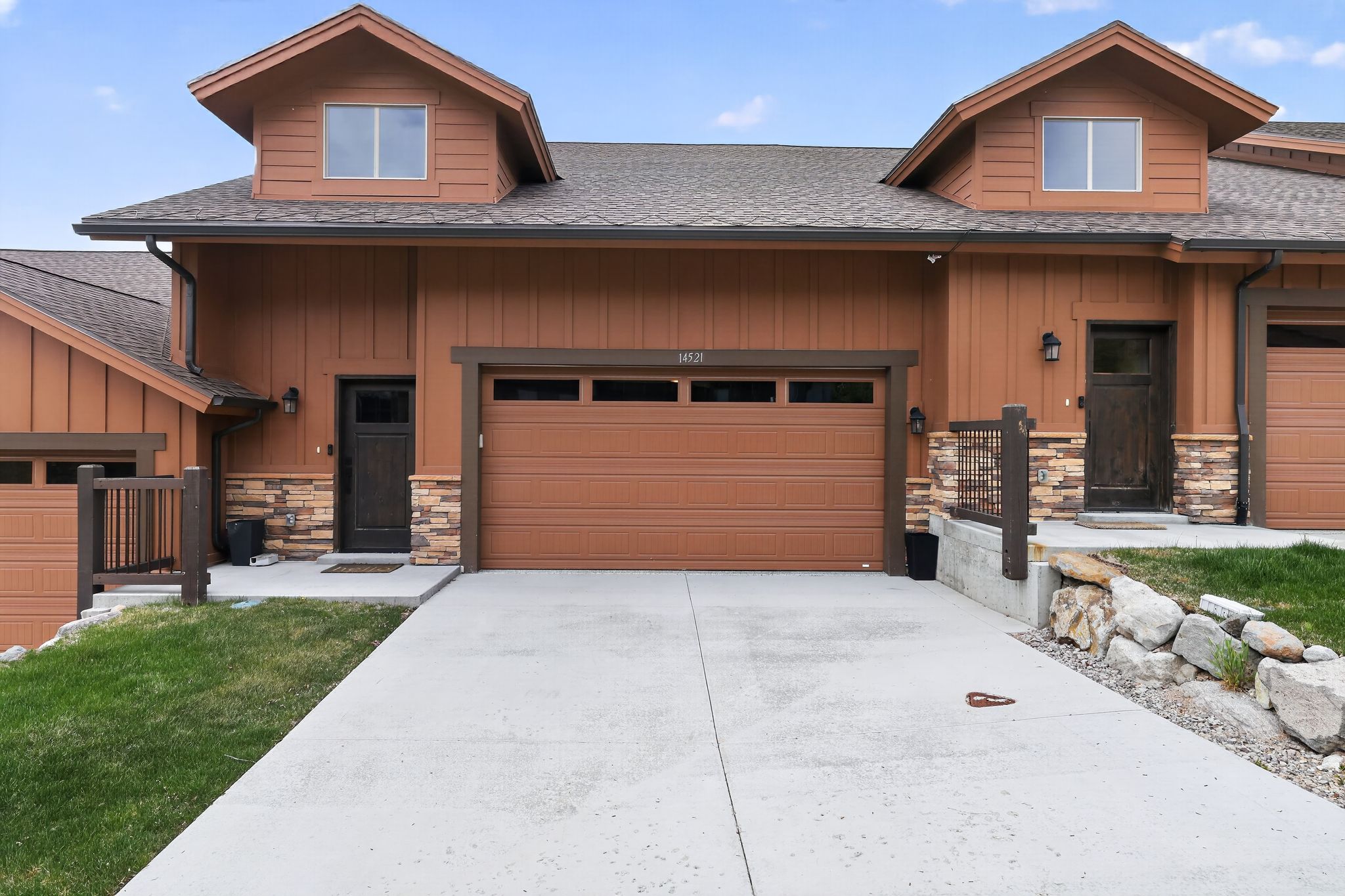 Exterior featuring vertical wood siding and stone accents