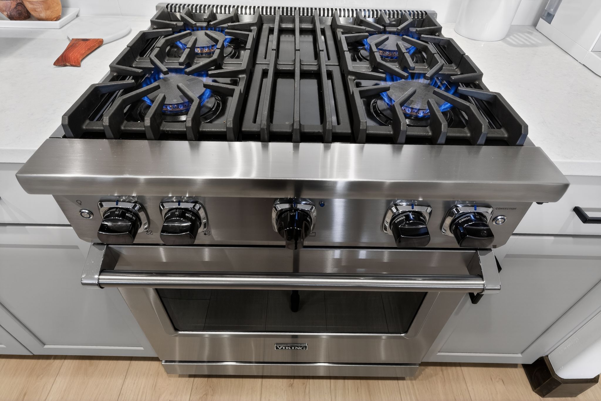 Stainless steel range with a four-burner gas cooktop, heavy-duty grates, and large control knobs