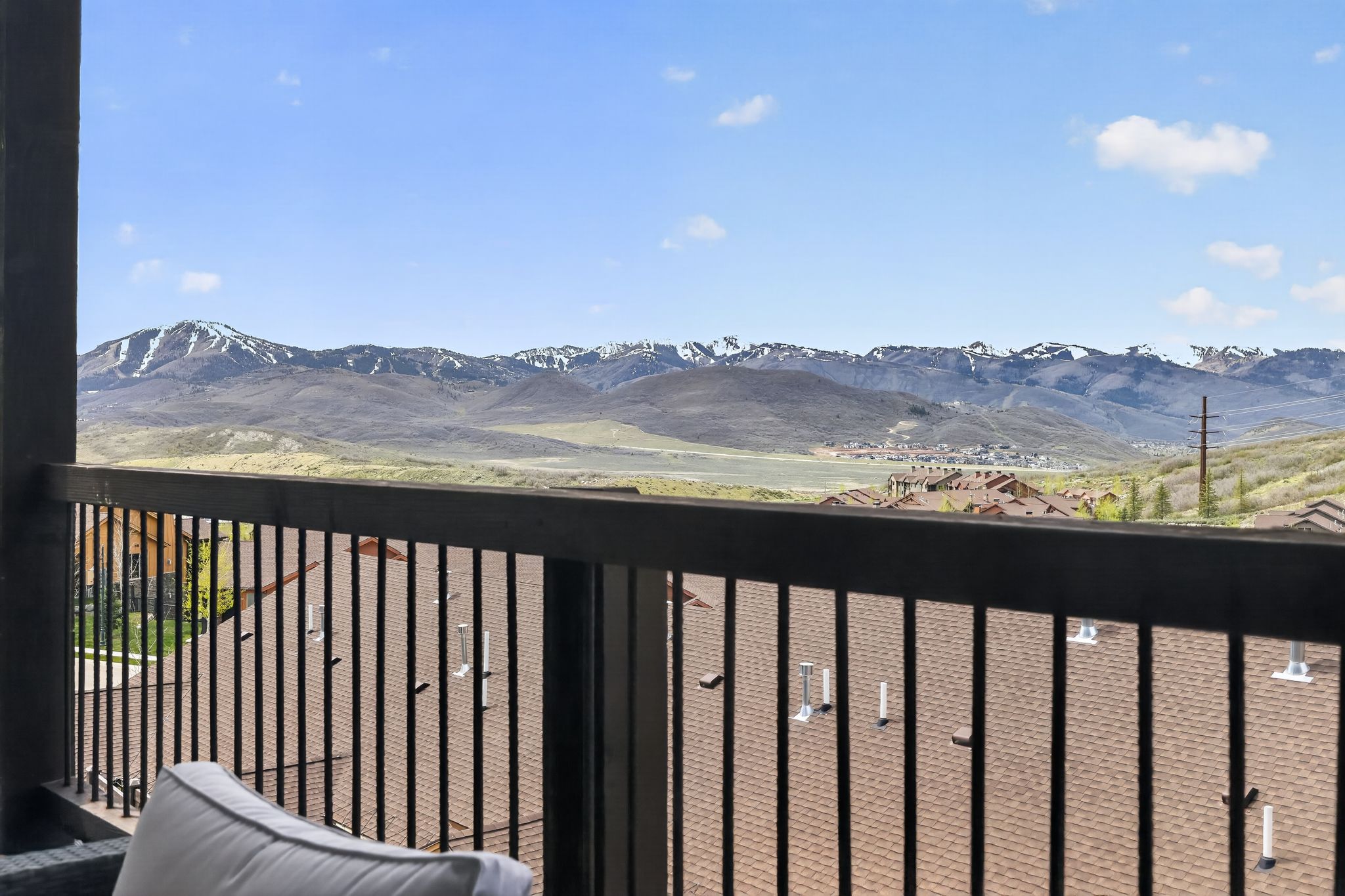 Balcony featuring dark-toned railings and a mountain backdrop