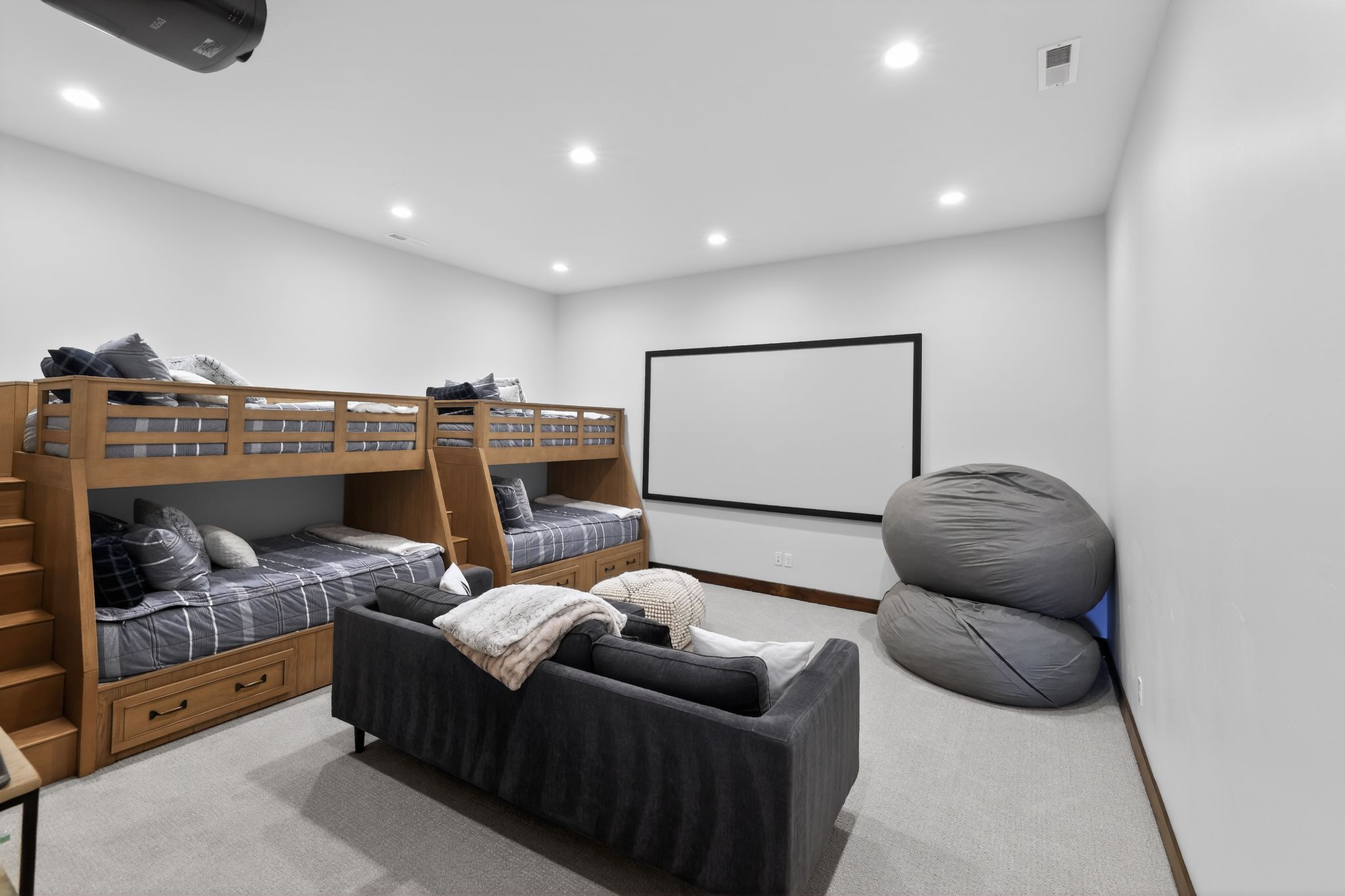 Entertainment room featuring a projection screen, recessed lighting, and carpet flooring