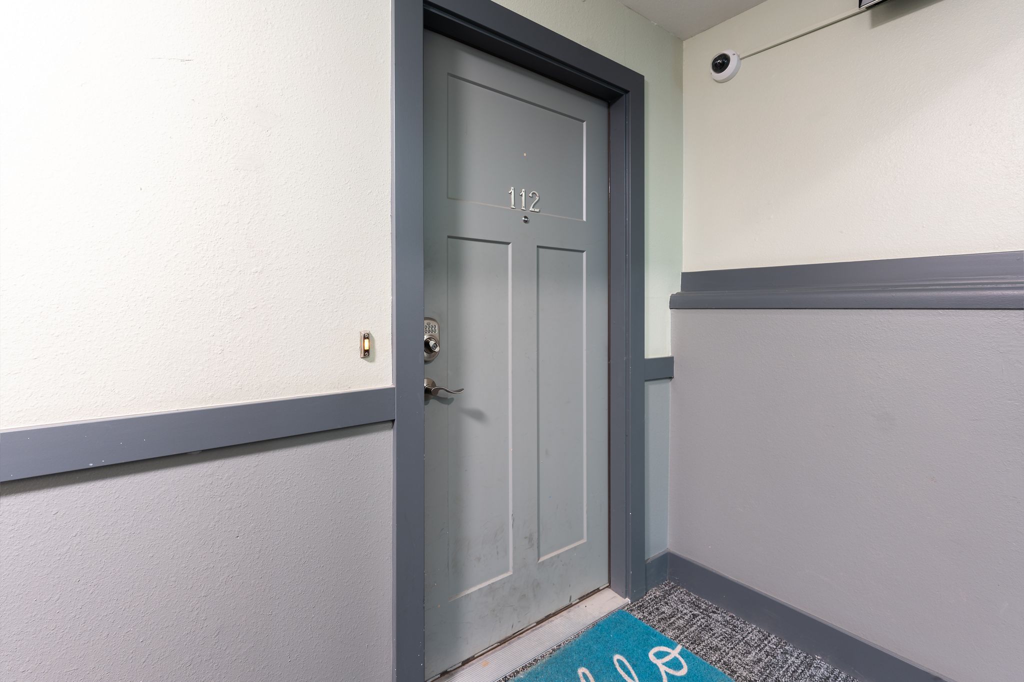 Entry door featuring a numbered plaque and polished hardware