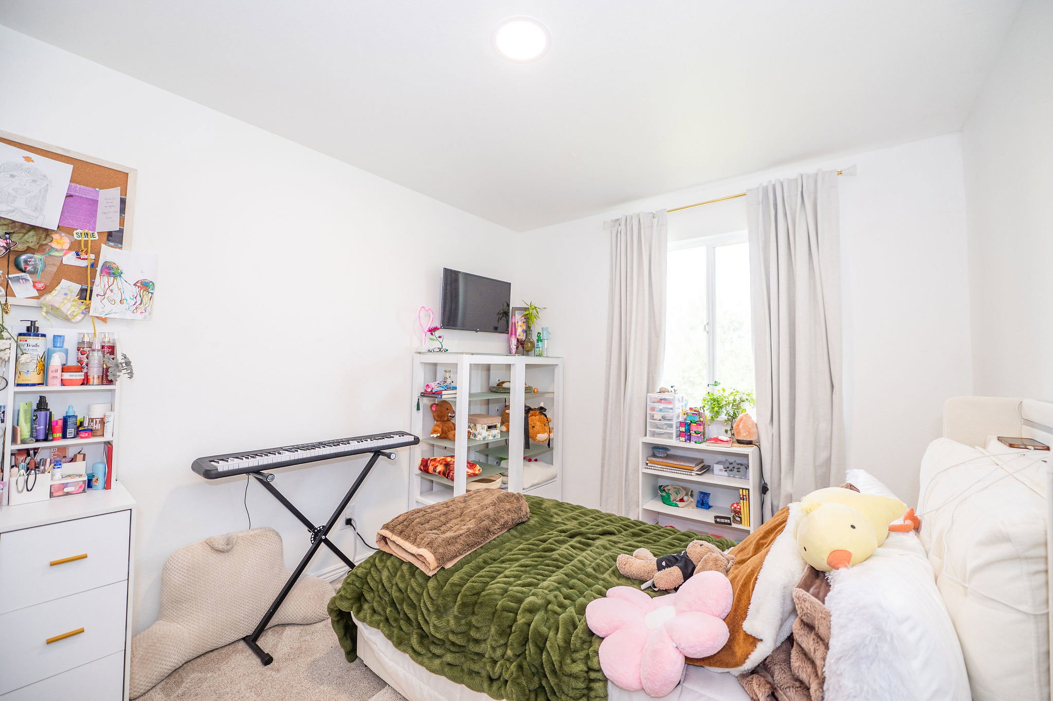 Bright interior space featuring a window with white trim, recessed ceiling lighting, and light-toned walls