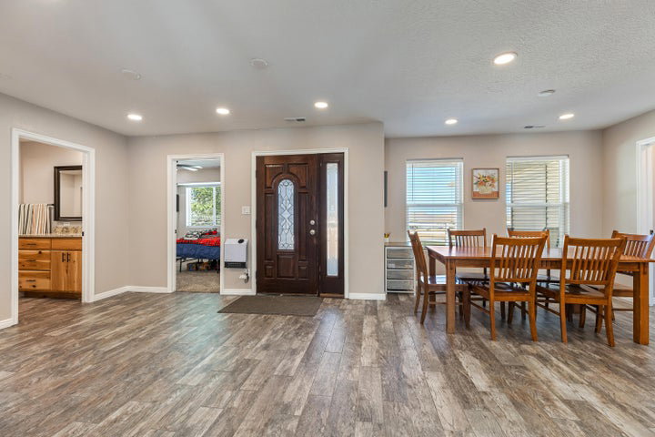 Spacious interior featuring wood-finish flooring, recessed lighting, and light-toned walls throughout