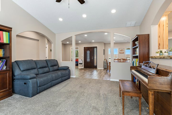 Carpeted living area featuring recessed lighting and a ceiling fan