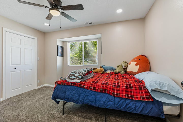 Room featuring a ceiling fan with integrated lighting, recessed lighting, and a window with blinds