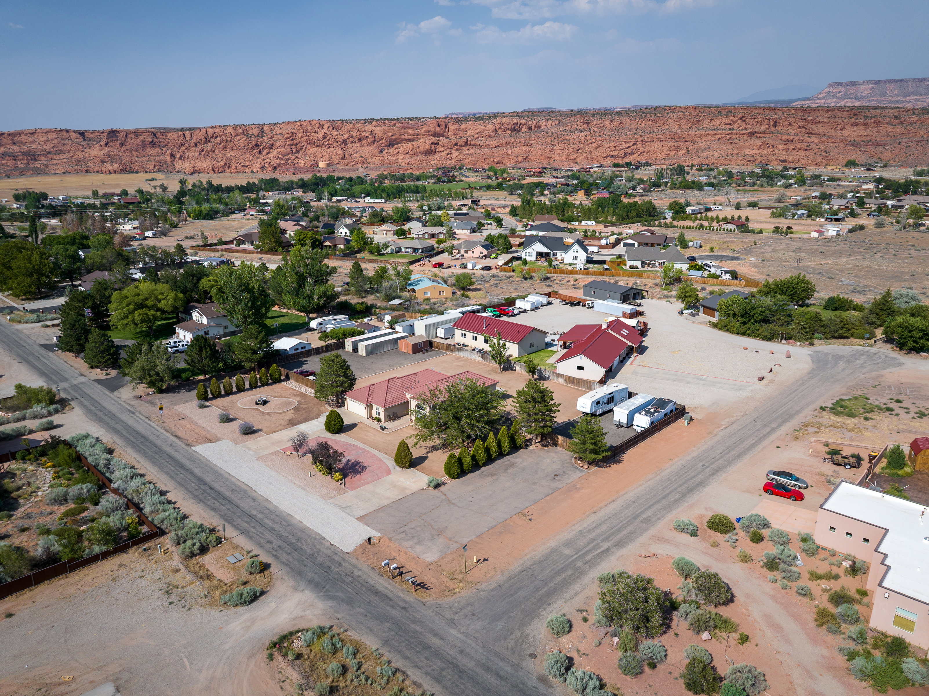 Aerial perspective showcasing multiple residential structures and extensive paved areas