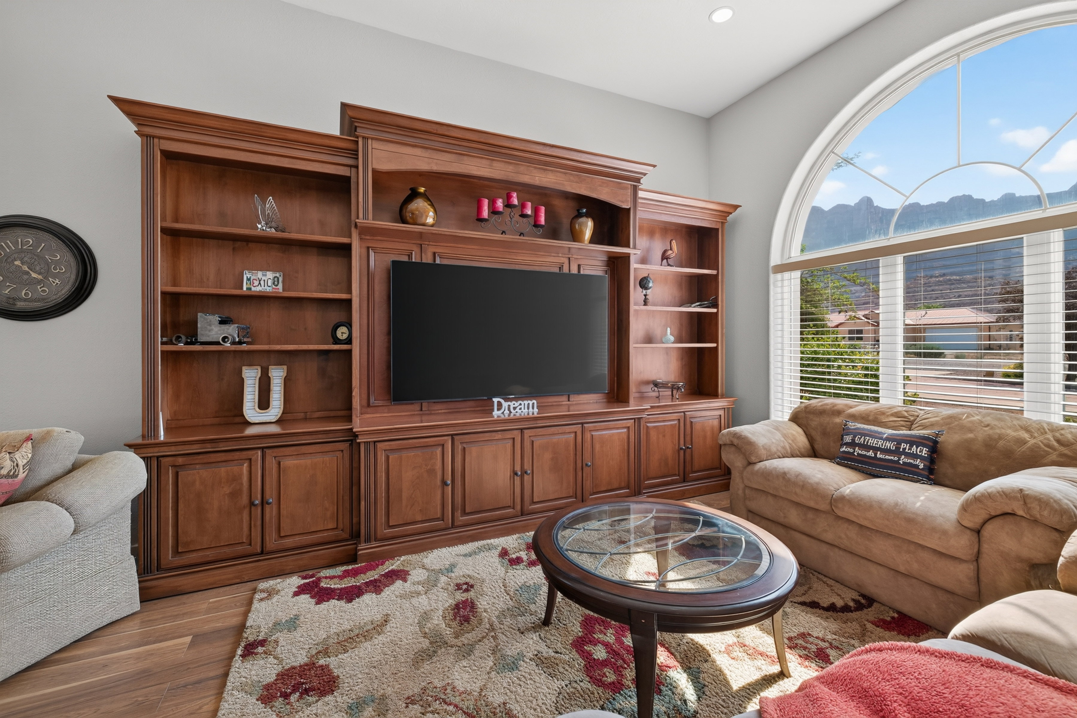 Custom built-in entertainment center in a rich wood finish with ample shelving and cabinet storage
