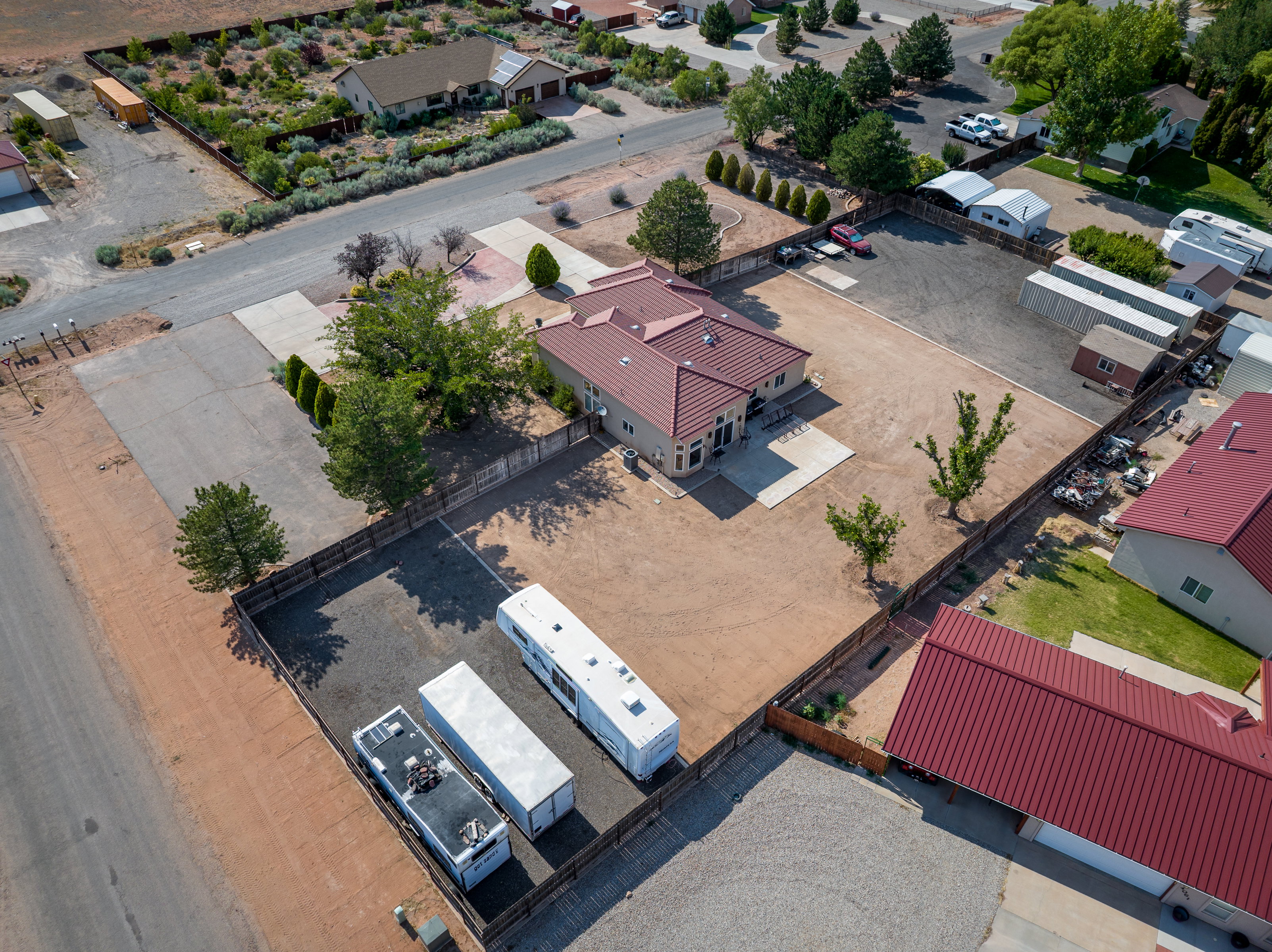 Aerial view showcasing a stucco exterior residence with a red tile roof