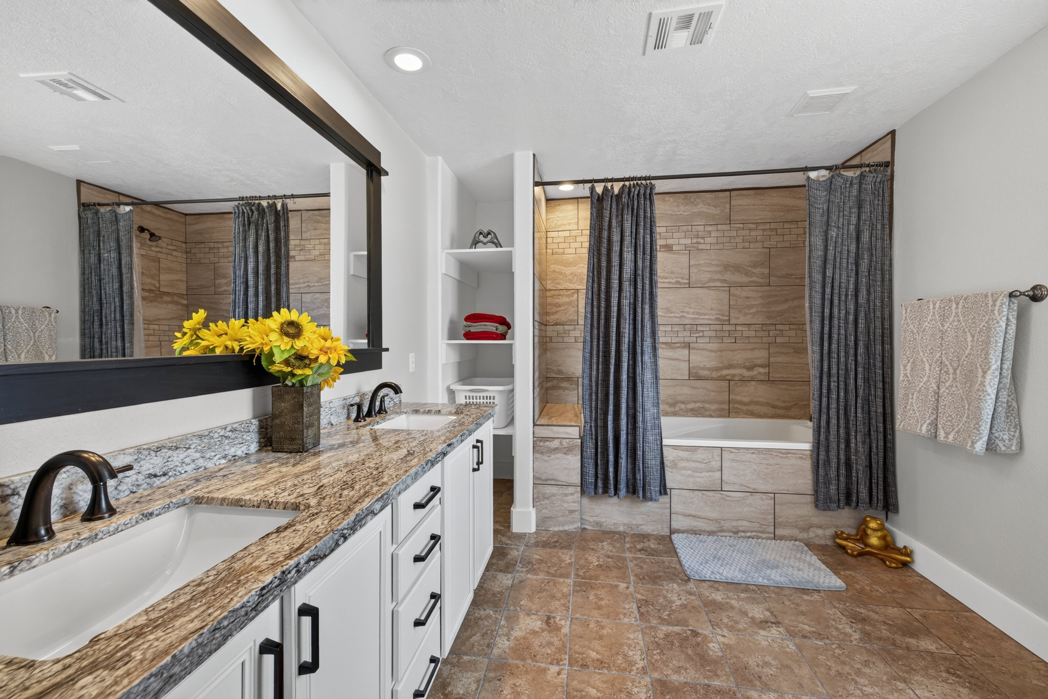 Dual vanity with undermount sinks and a stone-finish countertop