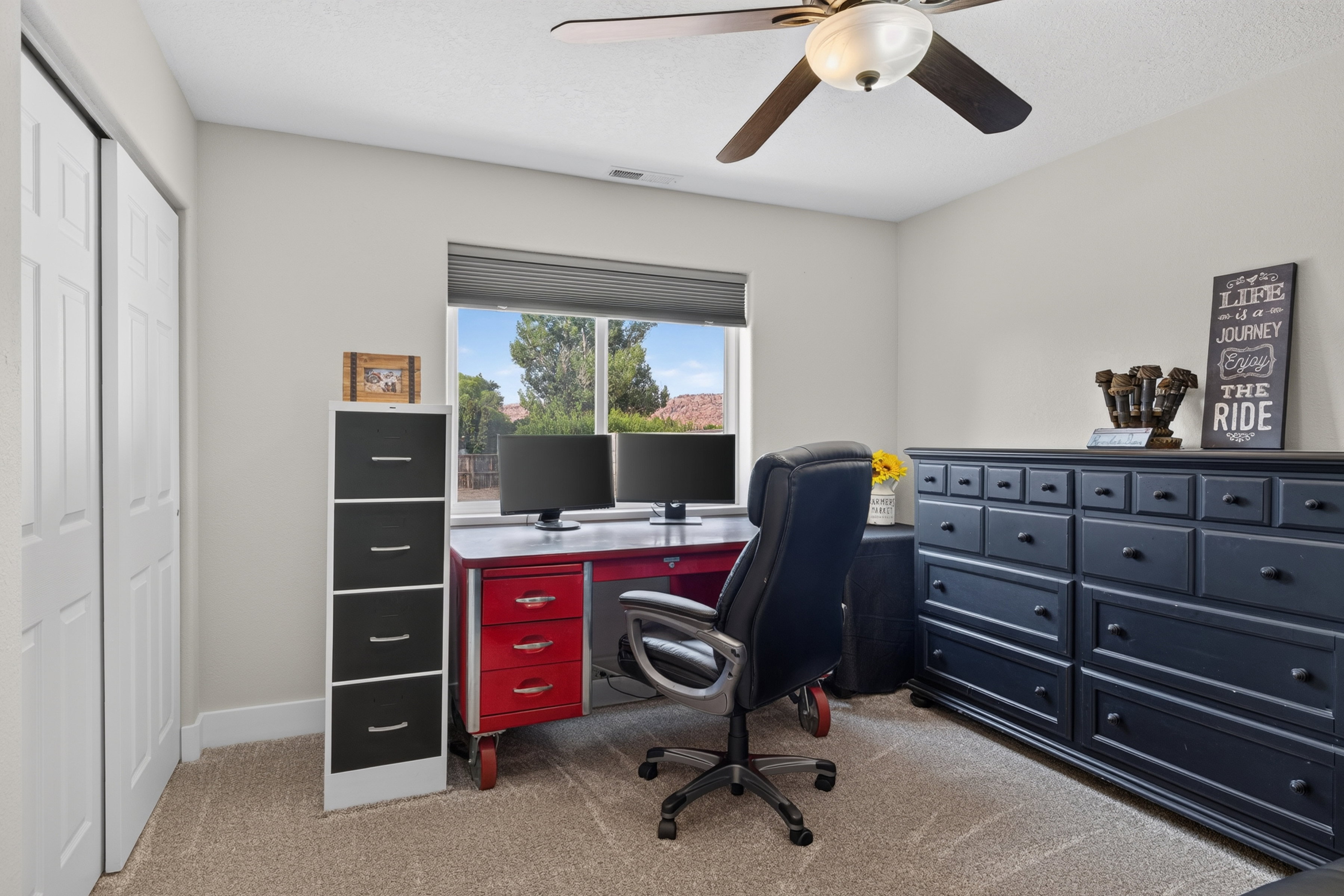 Bright room with neutral wall tones and textured carpet flooring