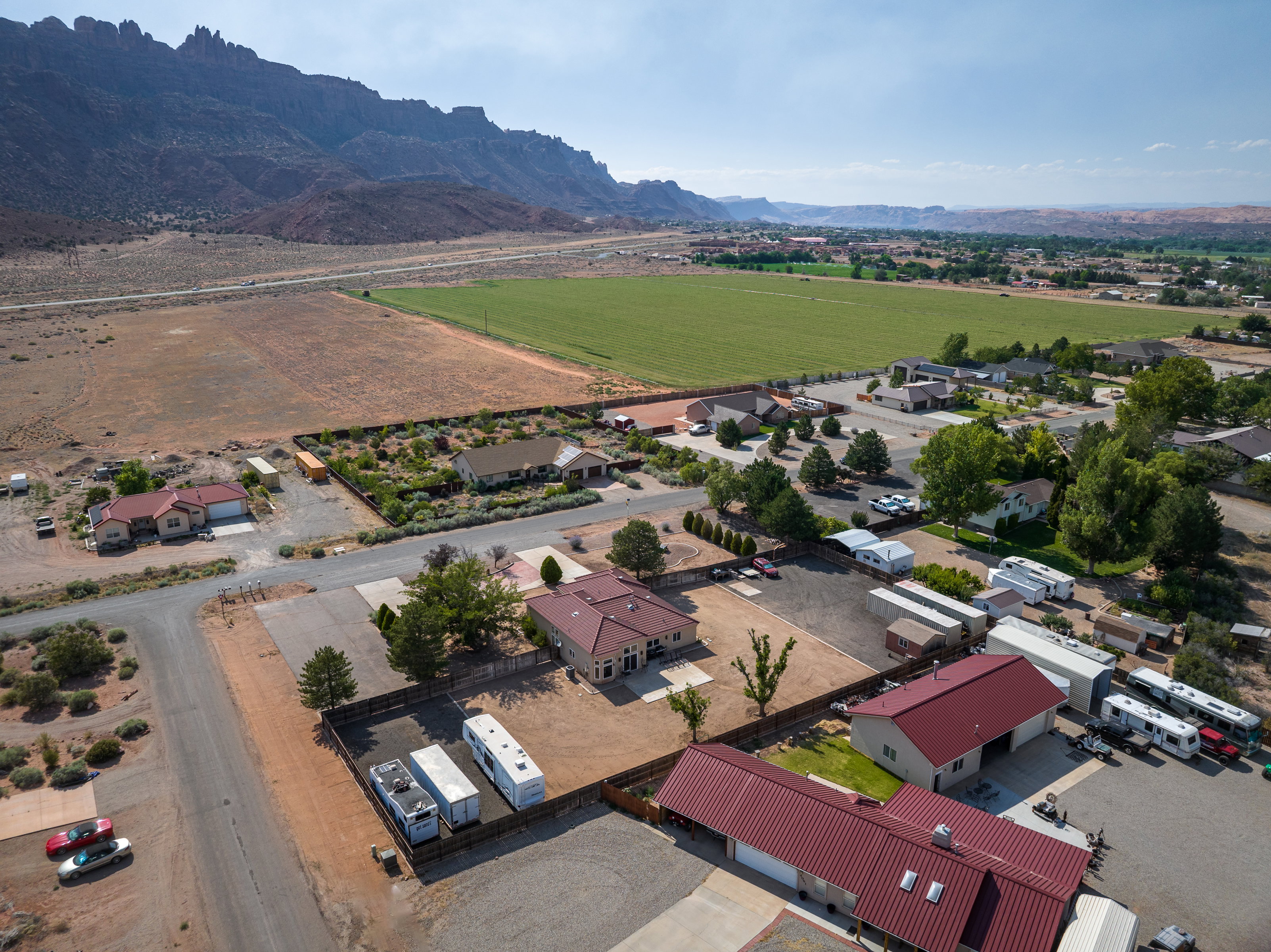 Expansive property featuring multiple structures, including two homes with red metal roofs
