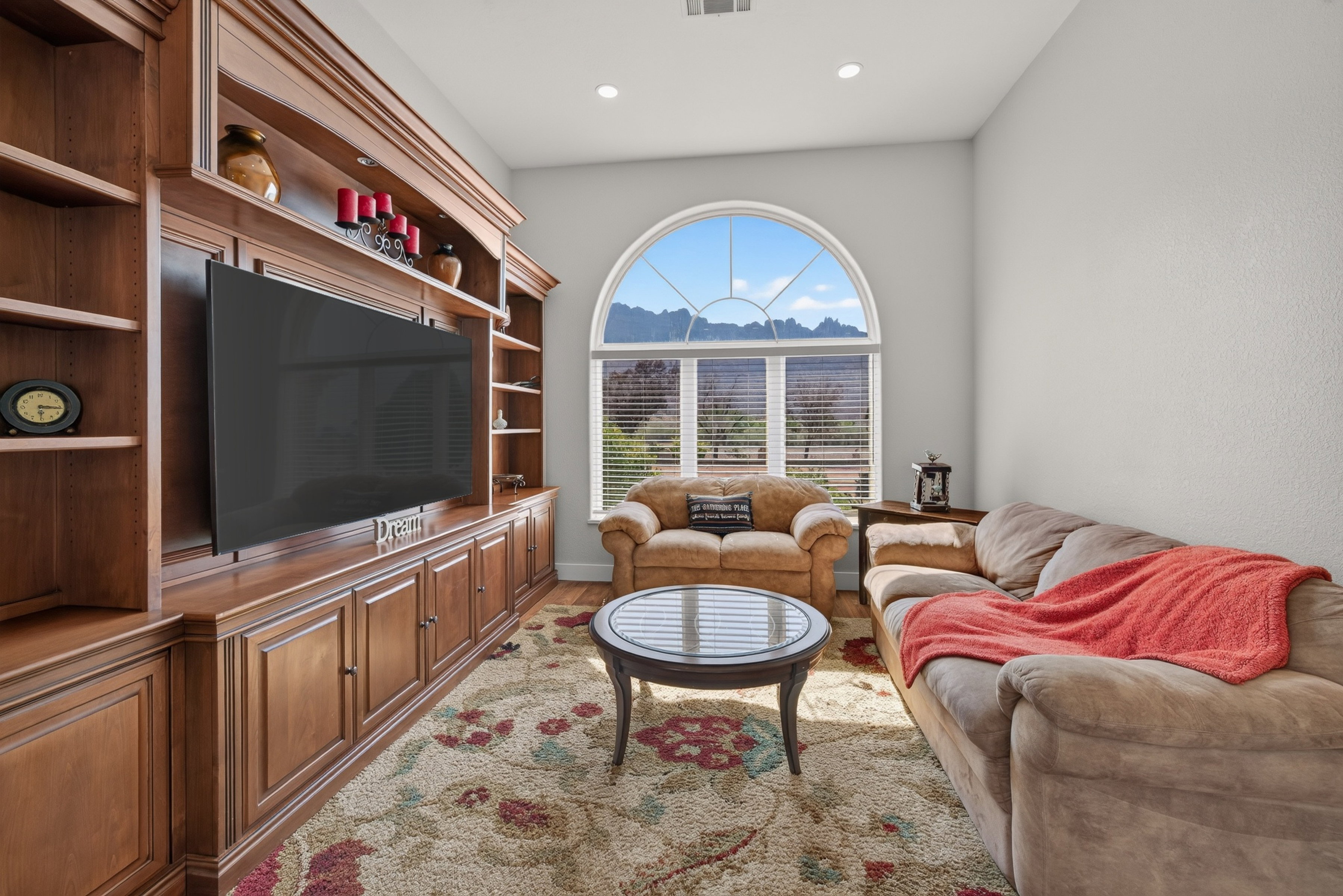 Built-in entertainment center featuring extensive wood cabinetry and shelving