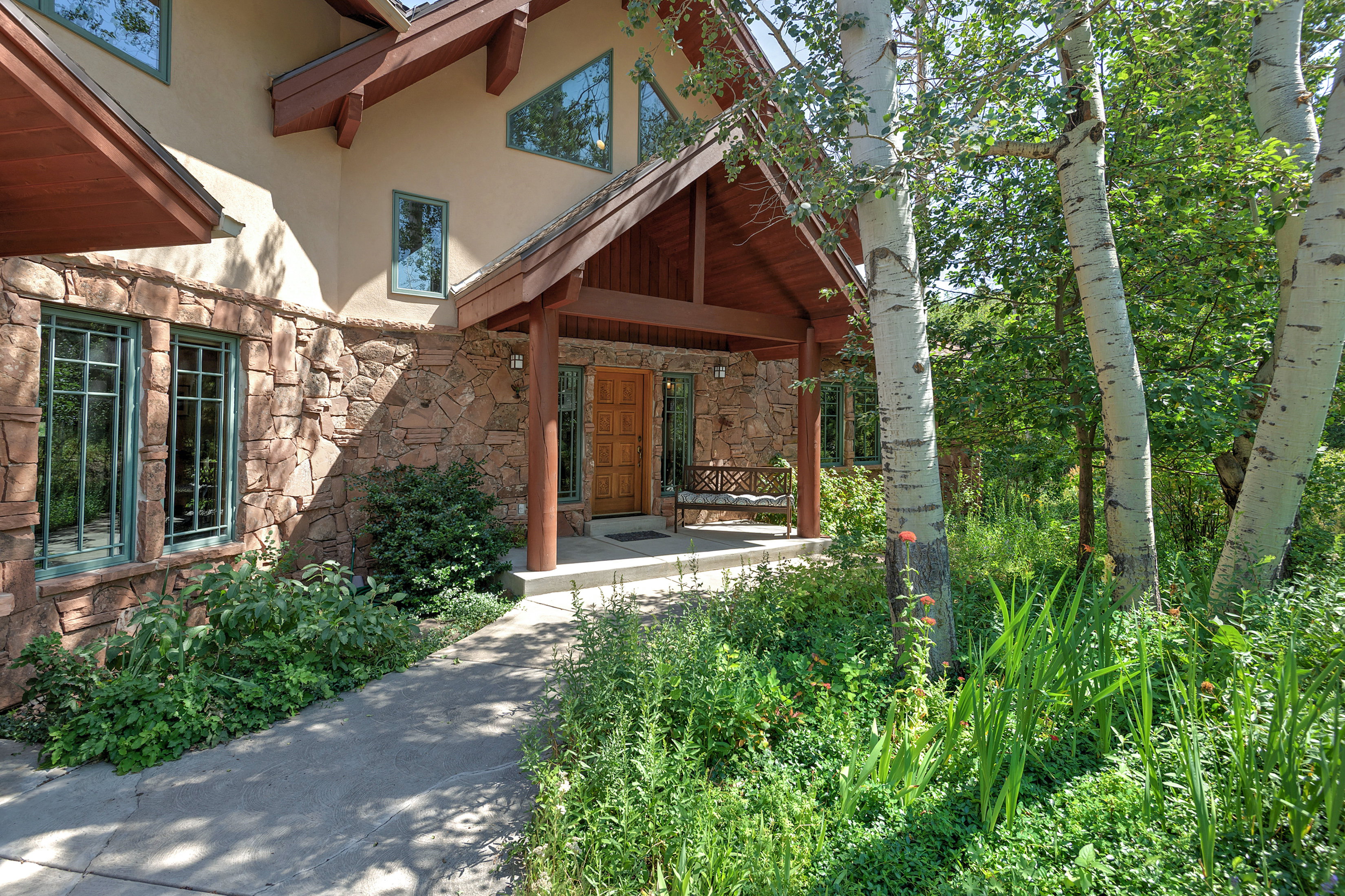 Stone and stucco exterior with a covered entry