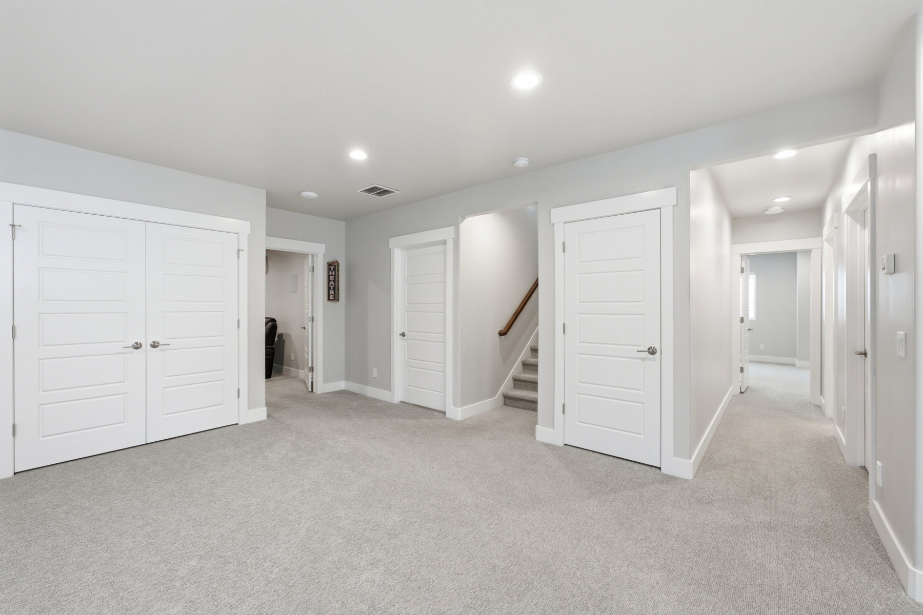 Lower level family room-view of stairs and hallway to bedroom