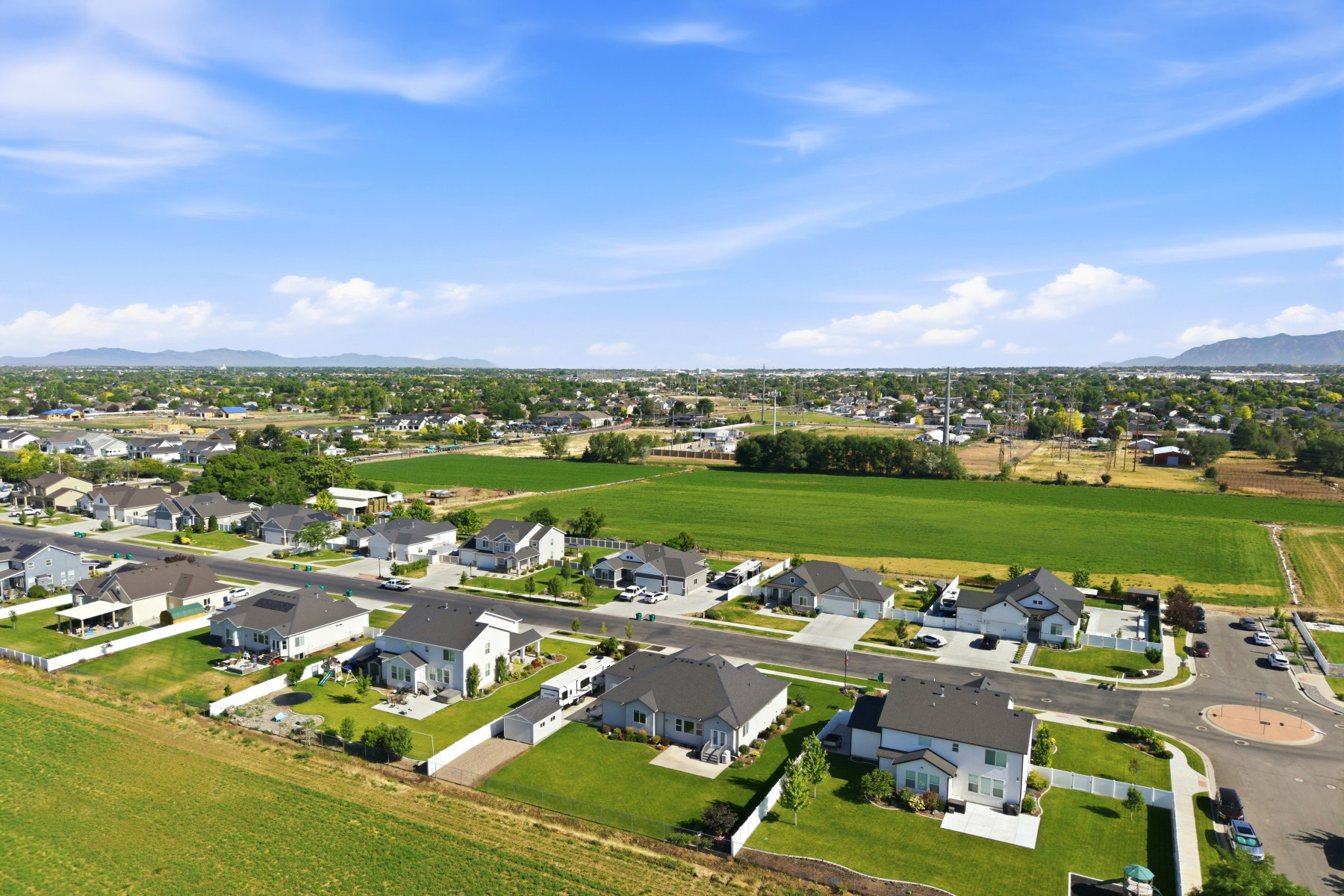 Expansive residential area featuring numerous single-family homes with diverse architectural styles, mature landscaping, and paved streets