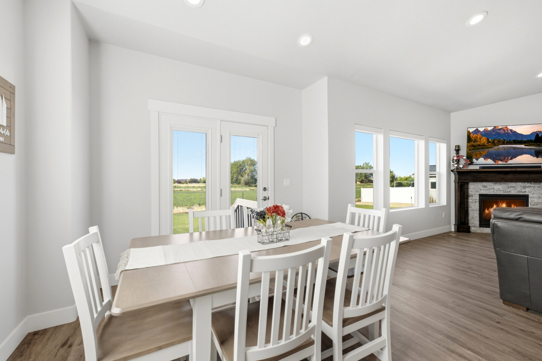 Dining area with wood-finish flooring and recessed lighting