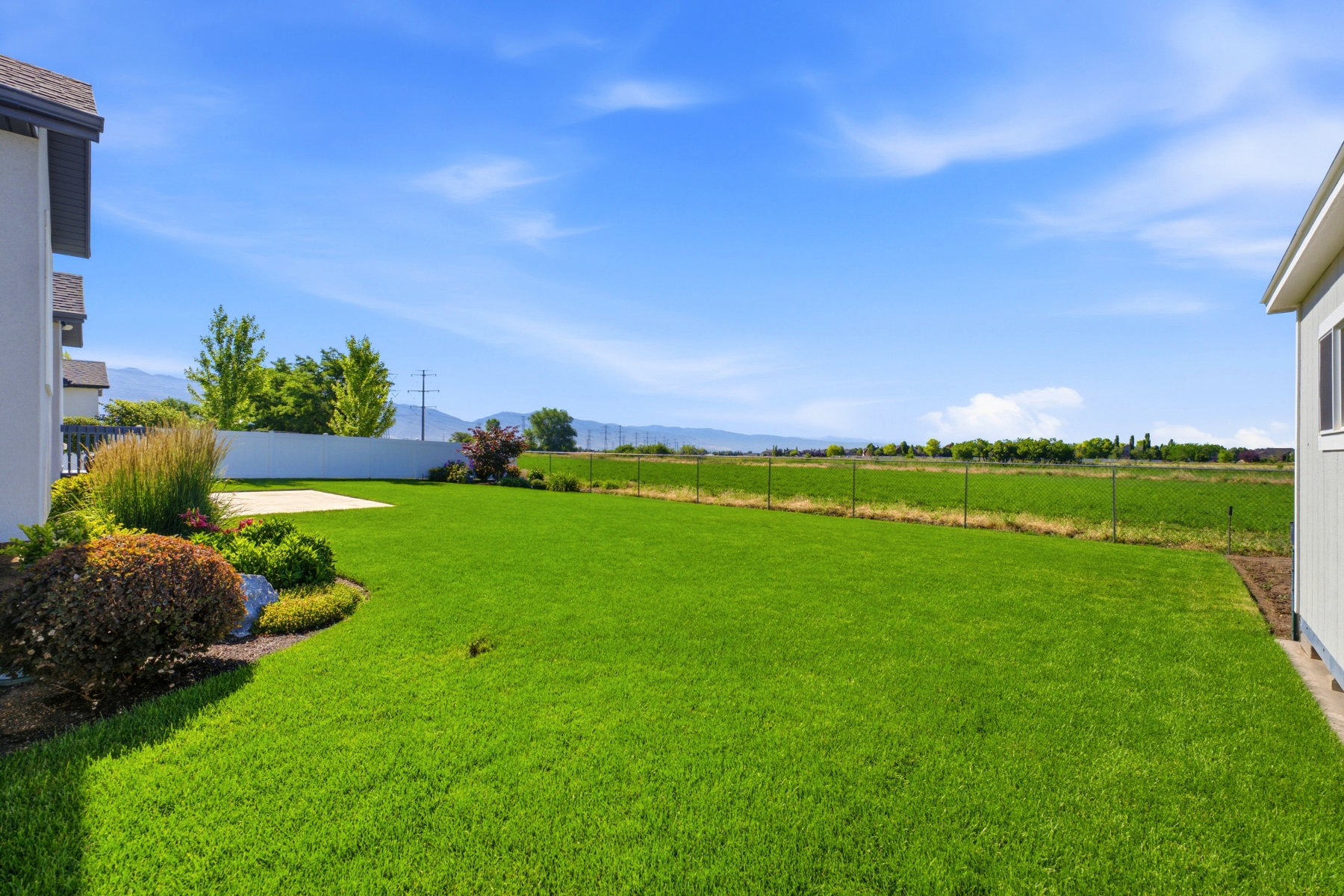 Expansive green lawn with mountain backdrop