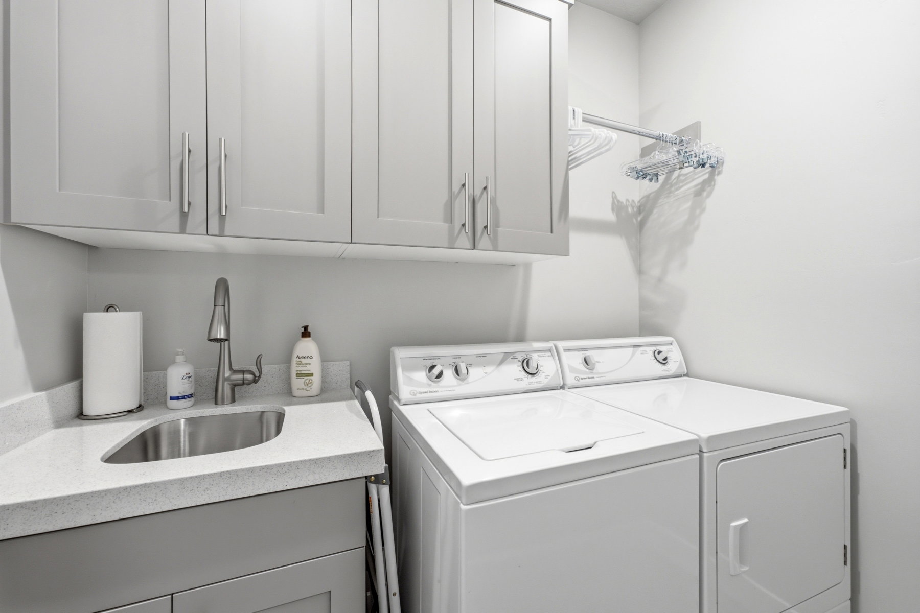 Main level laundry room with sink and cabinets