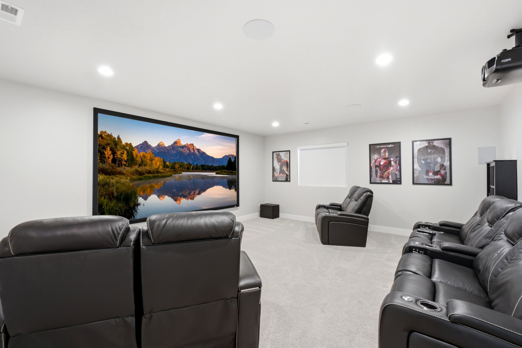 Dedicated media room featuring a large projection screen and built-in projector