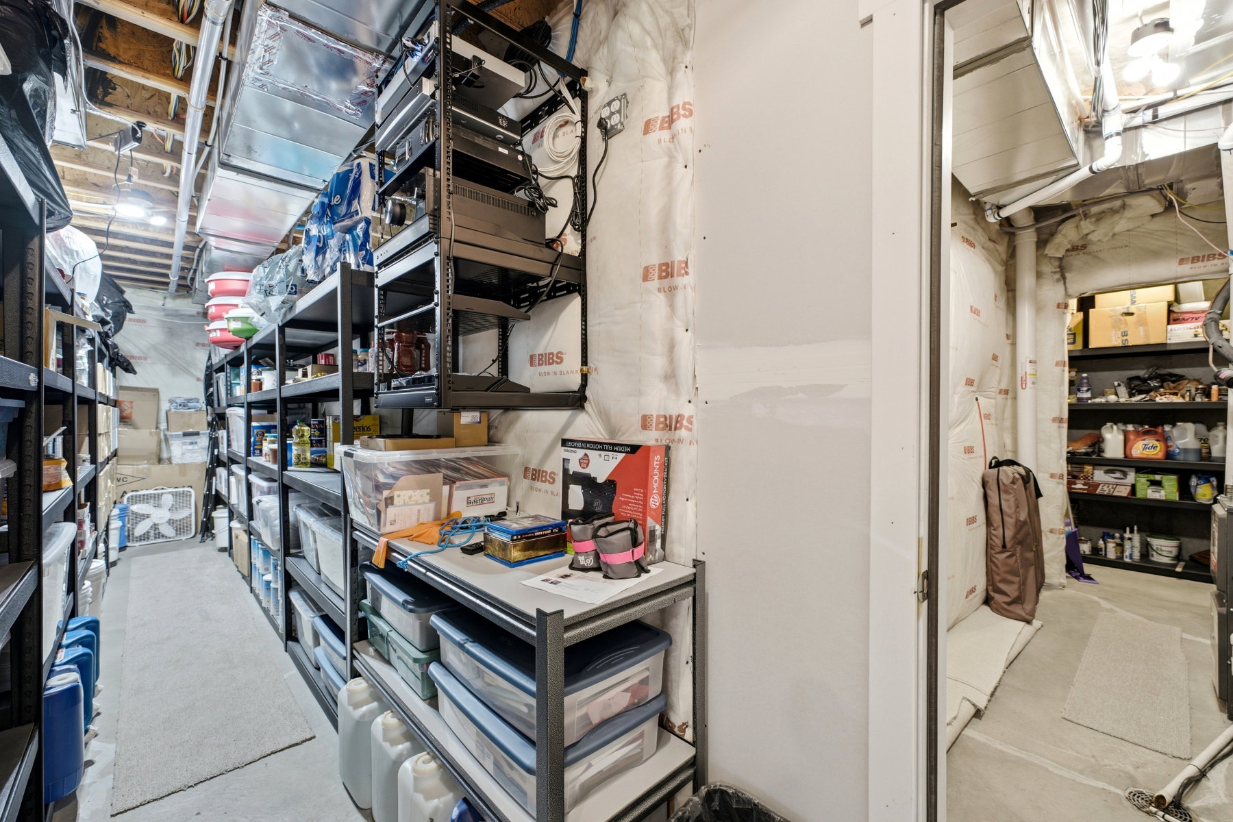 Storage room featuring extensive built-in metal shelving units for organized storage
