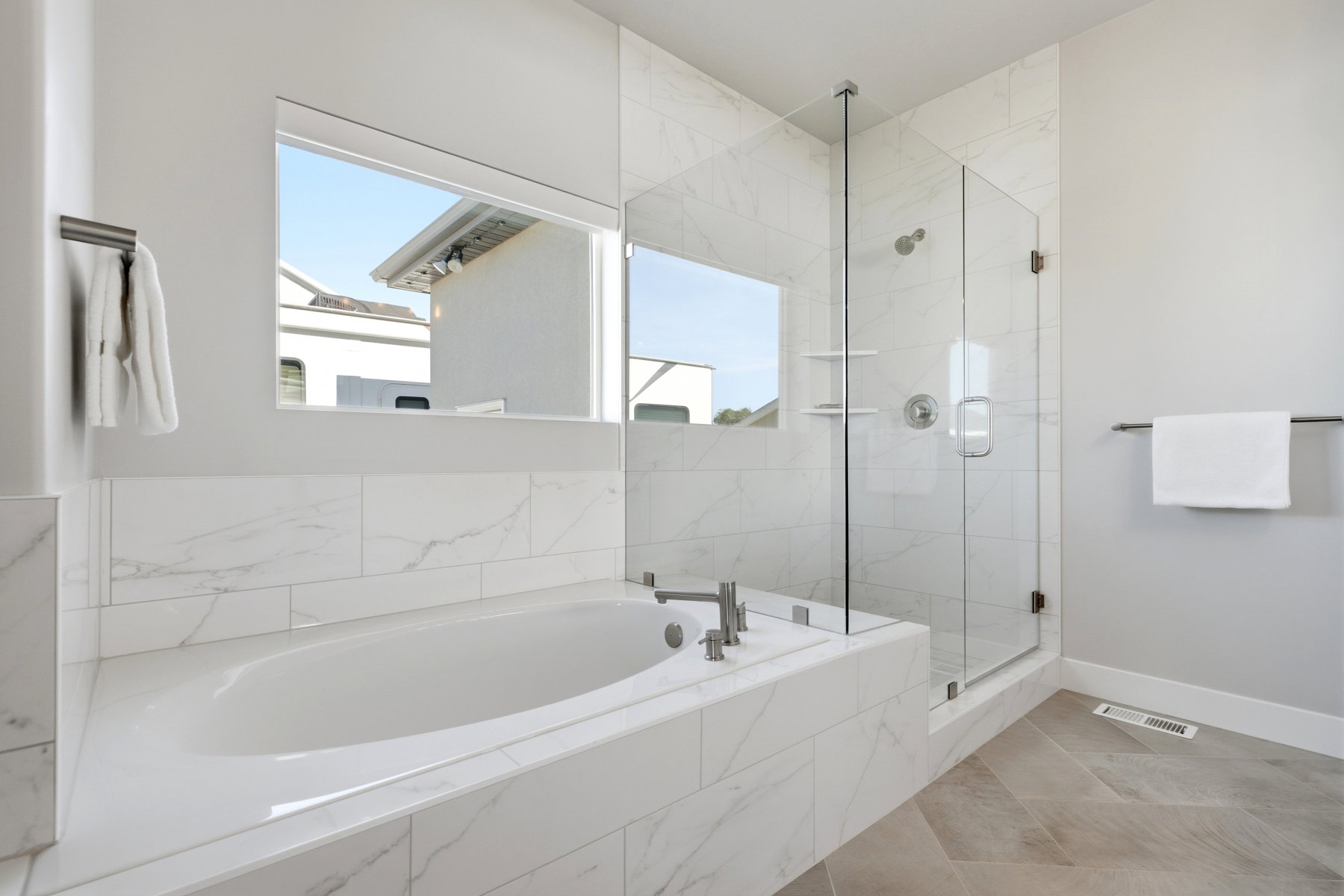Primary bedroom en-suite with soaking tub and shower