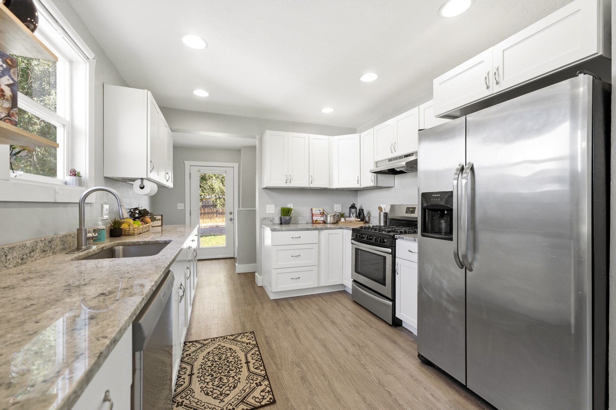 Renovated kitchen with granite countertops.