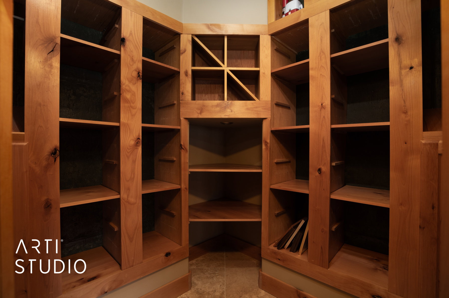 Custom wood shelving system featuring adjustable shelves and a dedicated wine rack