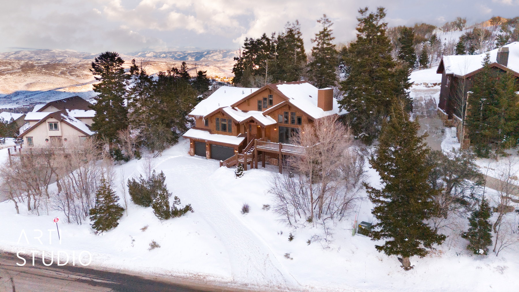 Wood-sided residence with multiple gables and a stone chimney