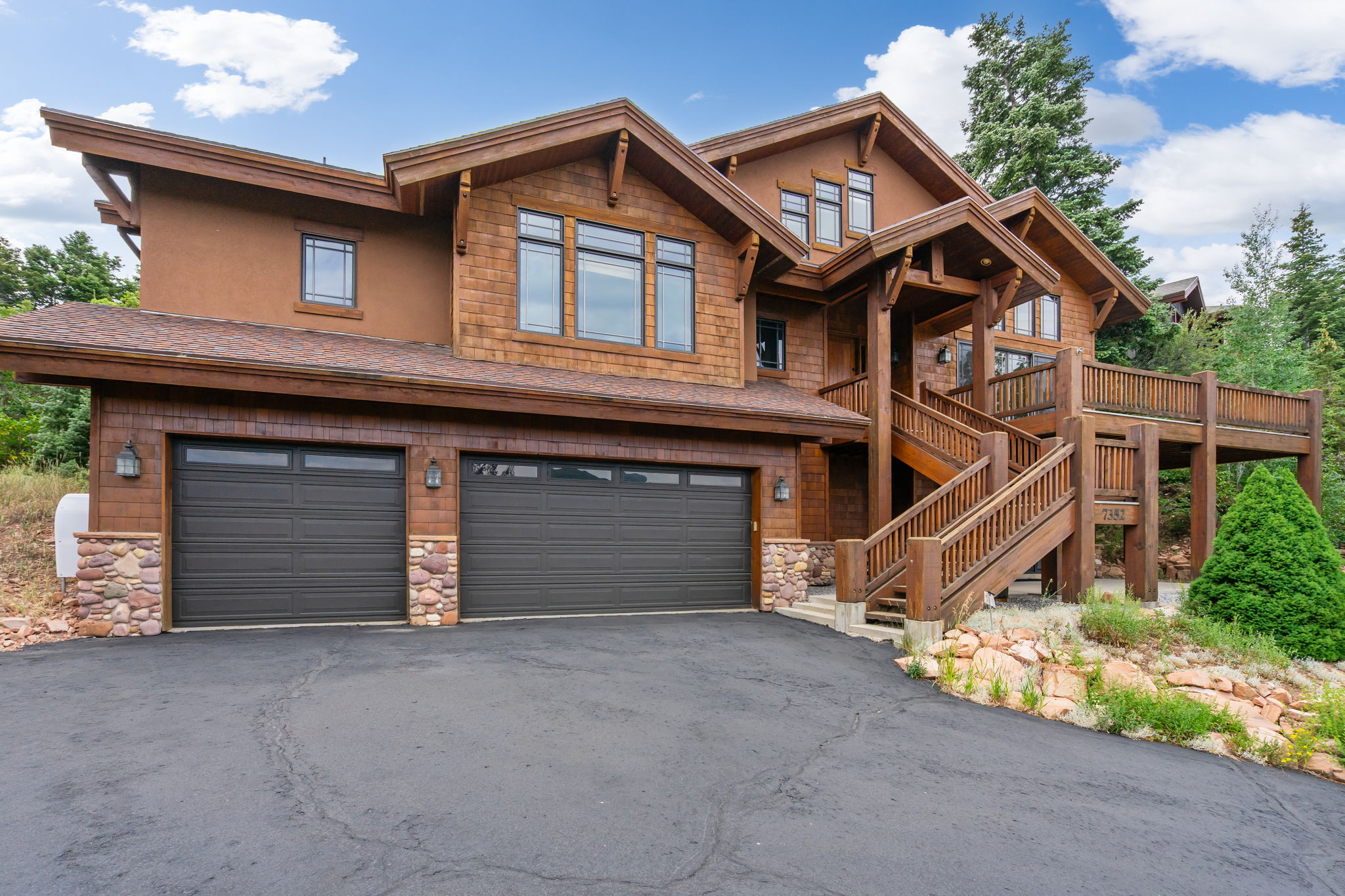 Rustic architectural design featuring rich wood siding and stone accents