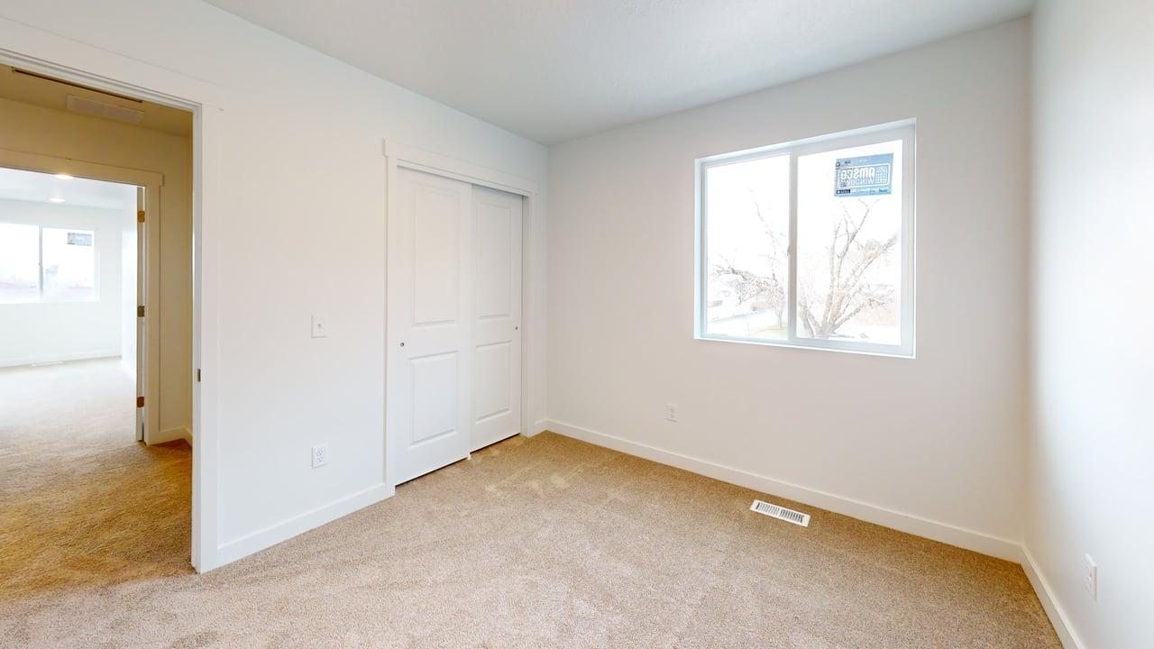 Neutral tone carpet flooring with white baseboards