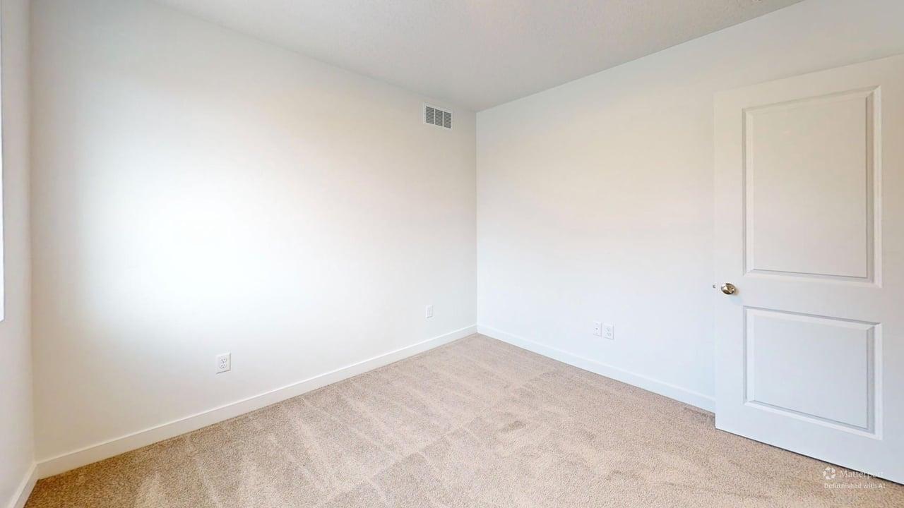 Neutral-toned carpeting and light-colored walls define this room