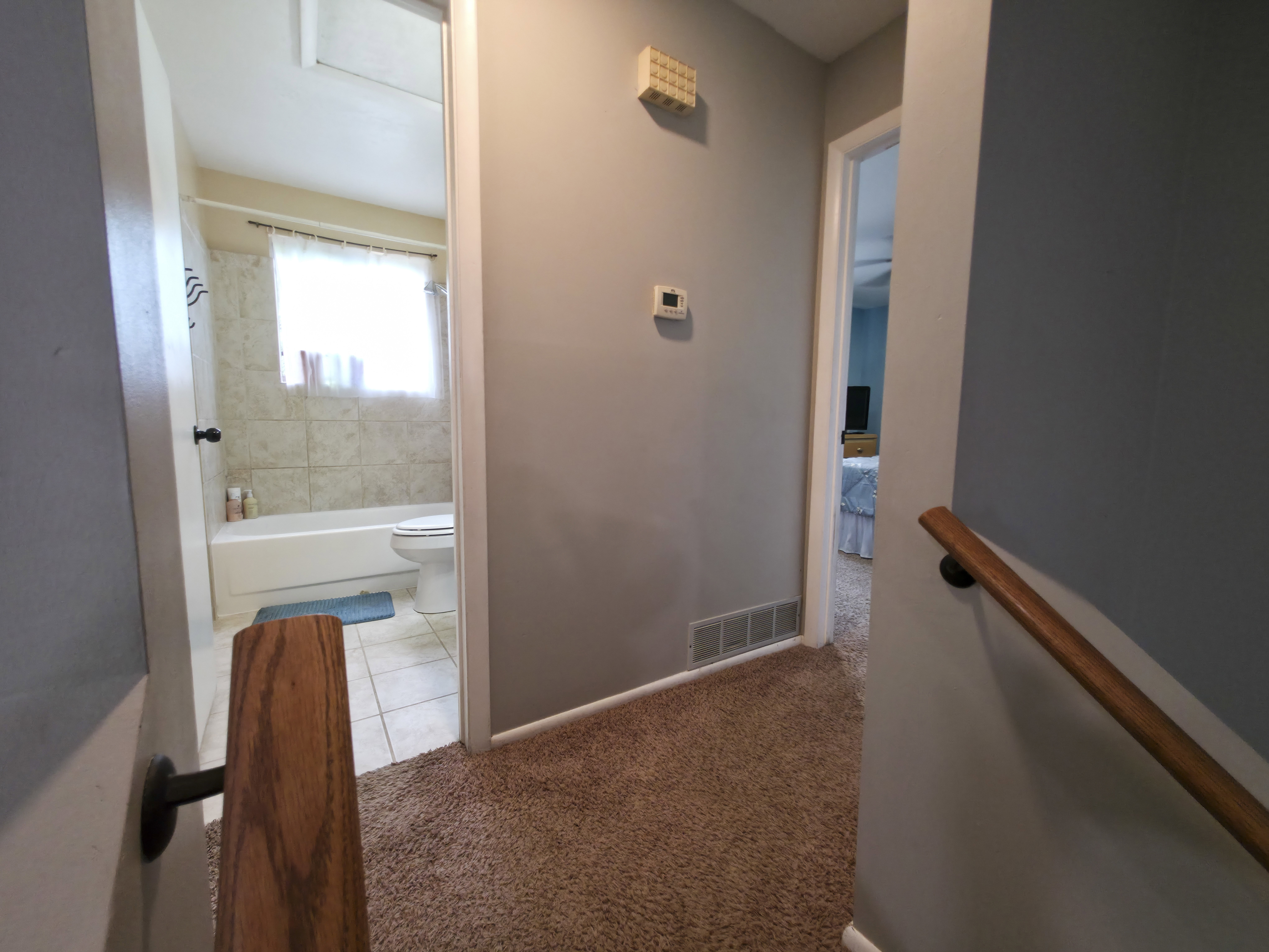 Bathroom center. Primary bedroom on right.