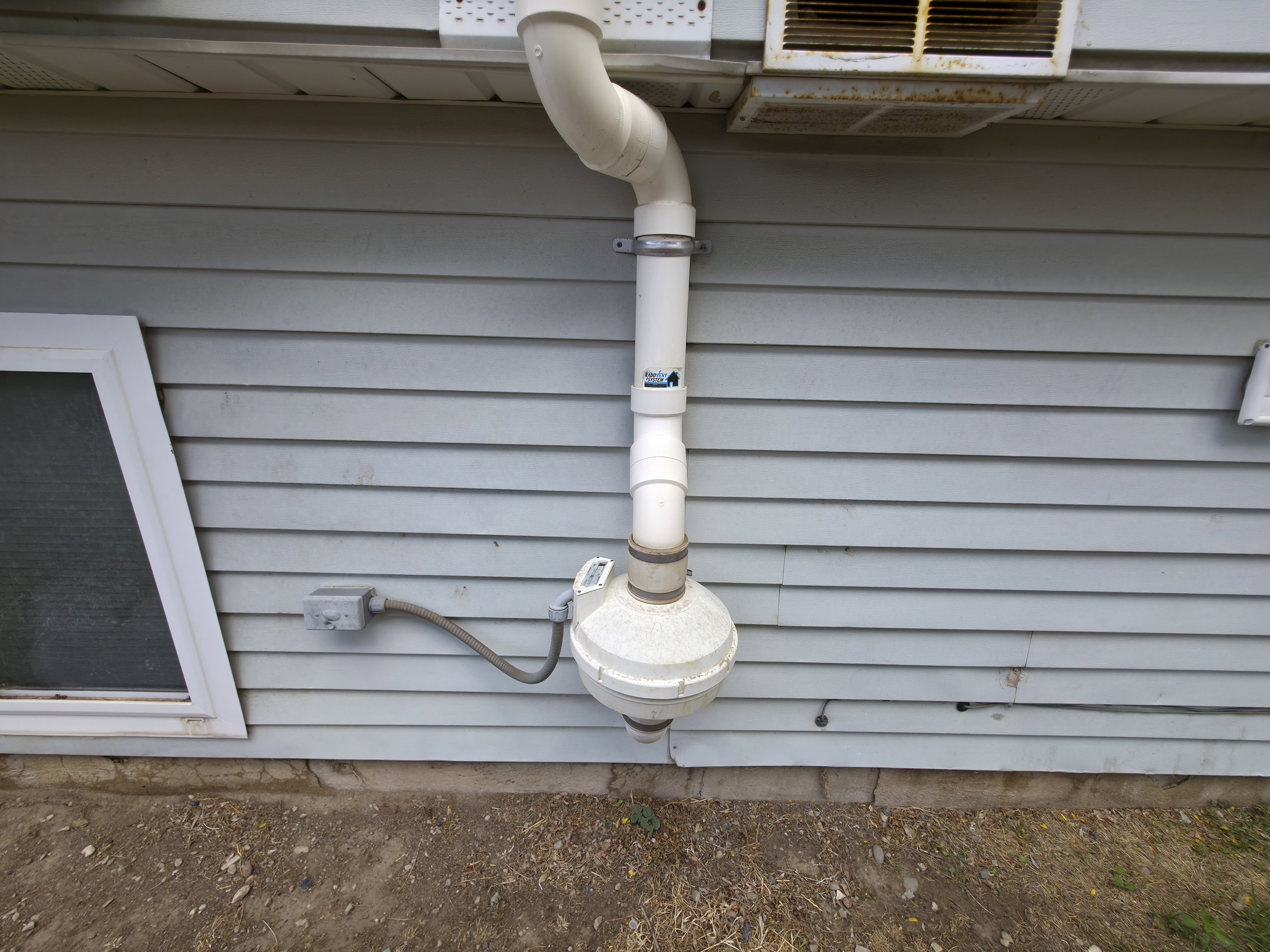 Back yard: low voltage radon system fan and vent.