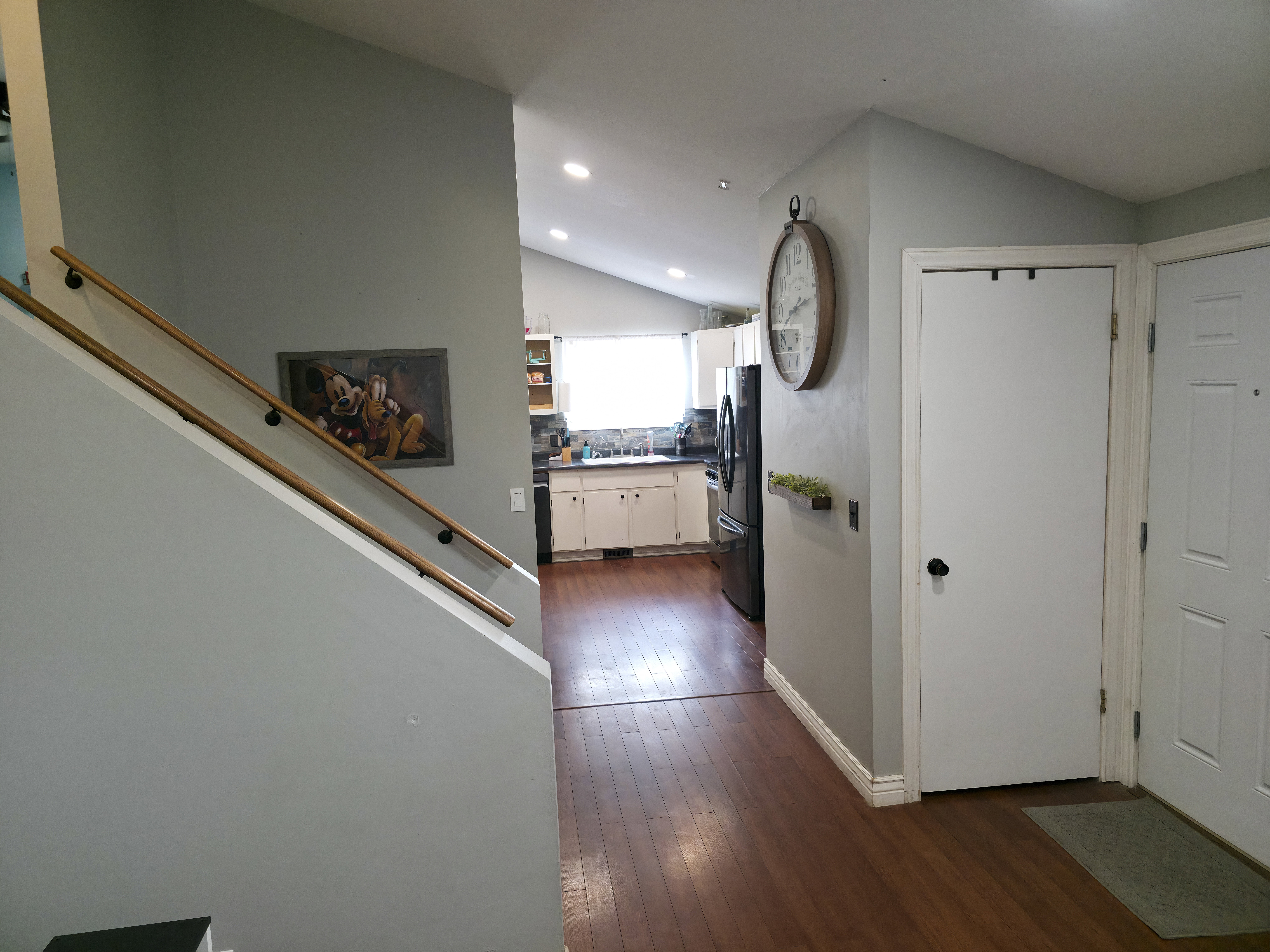 Stairs up, then down on right. Kitchen center. Front door on right.