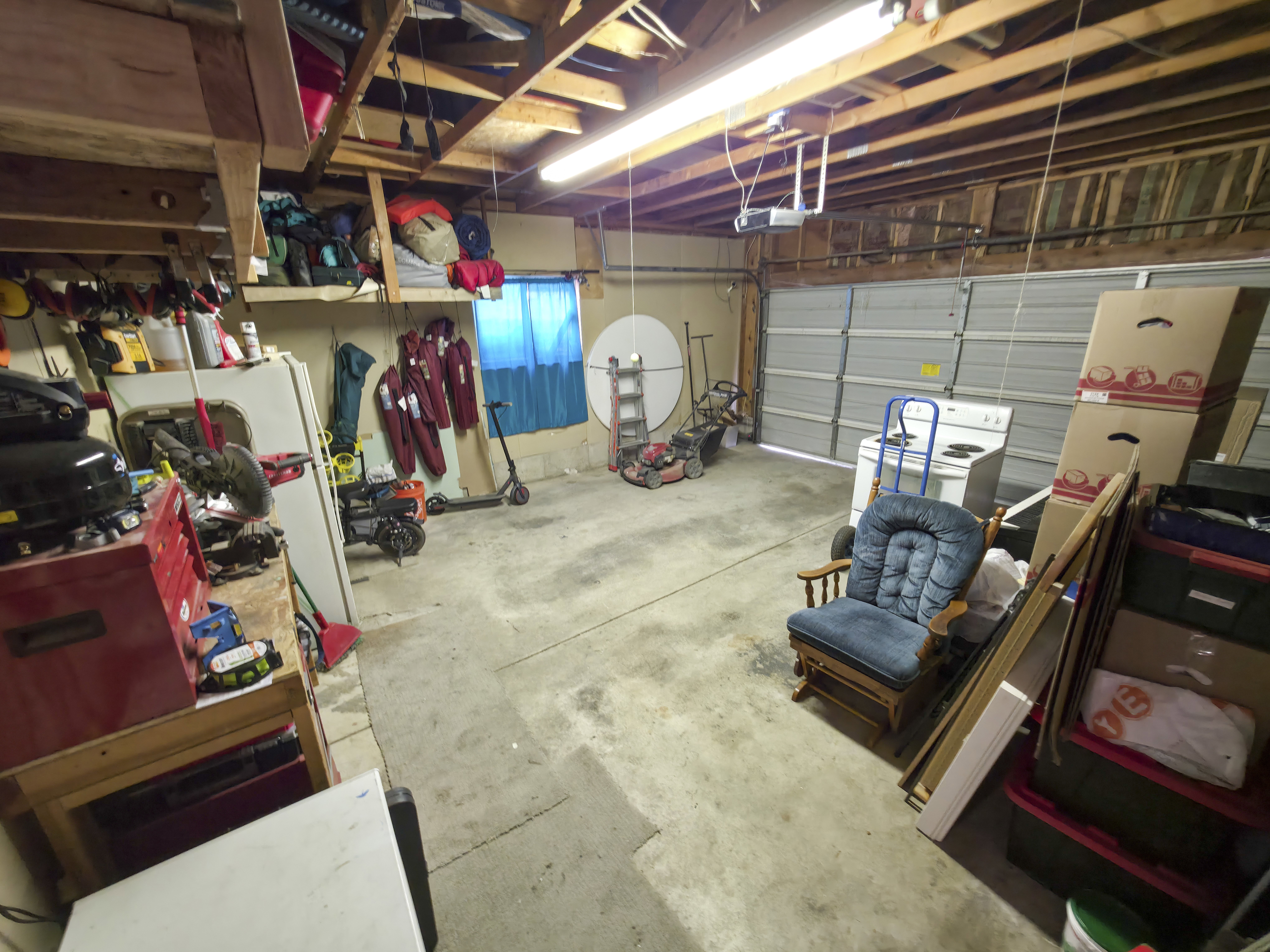 Attached garage: built in shelving and  workbench.