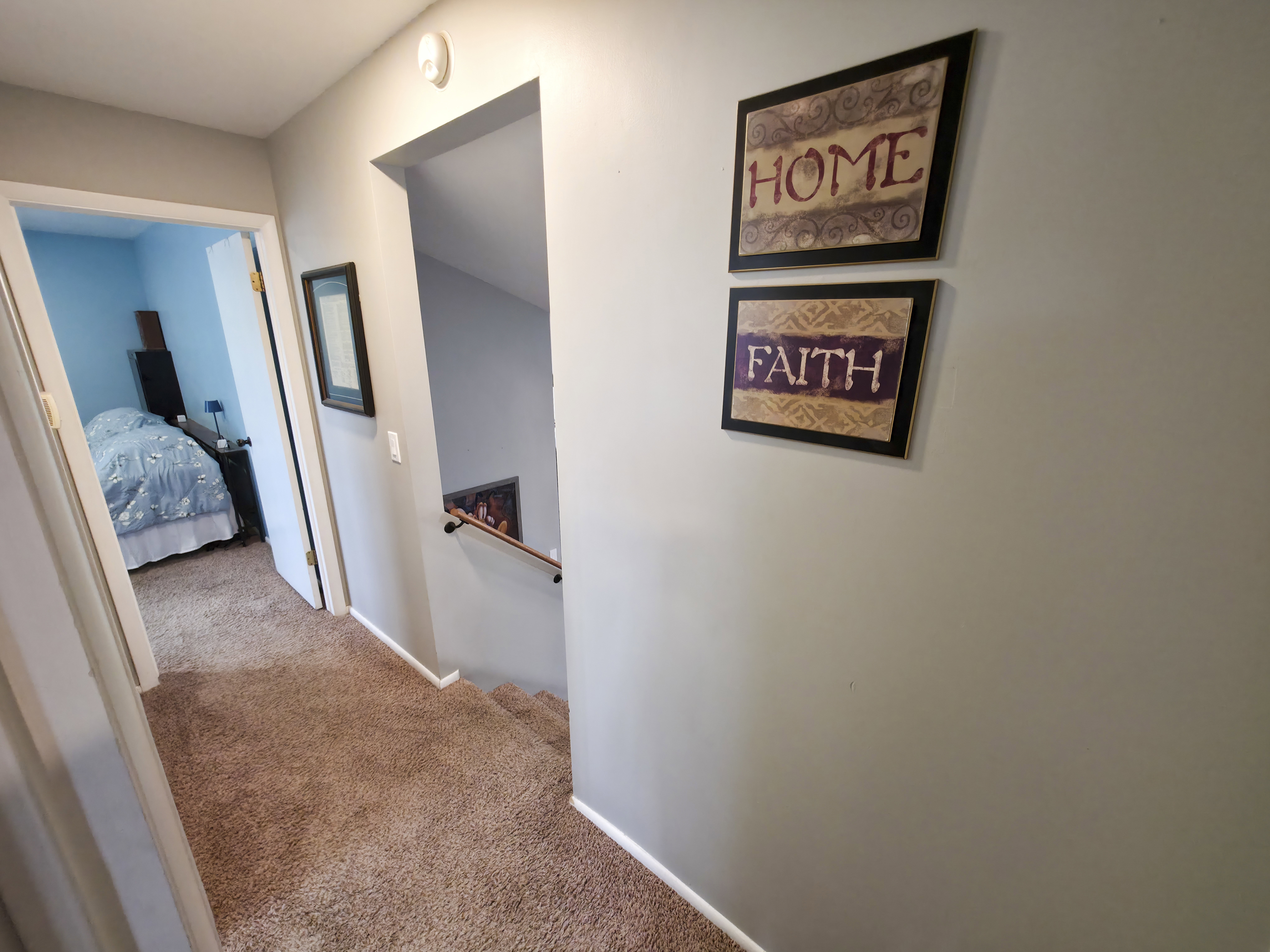 Bathroom 1 at left. Primary bedroom center. Stairs down on right.