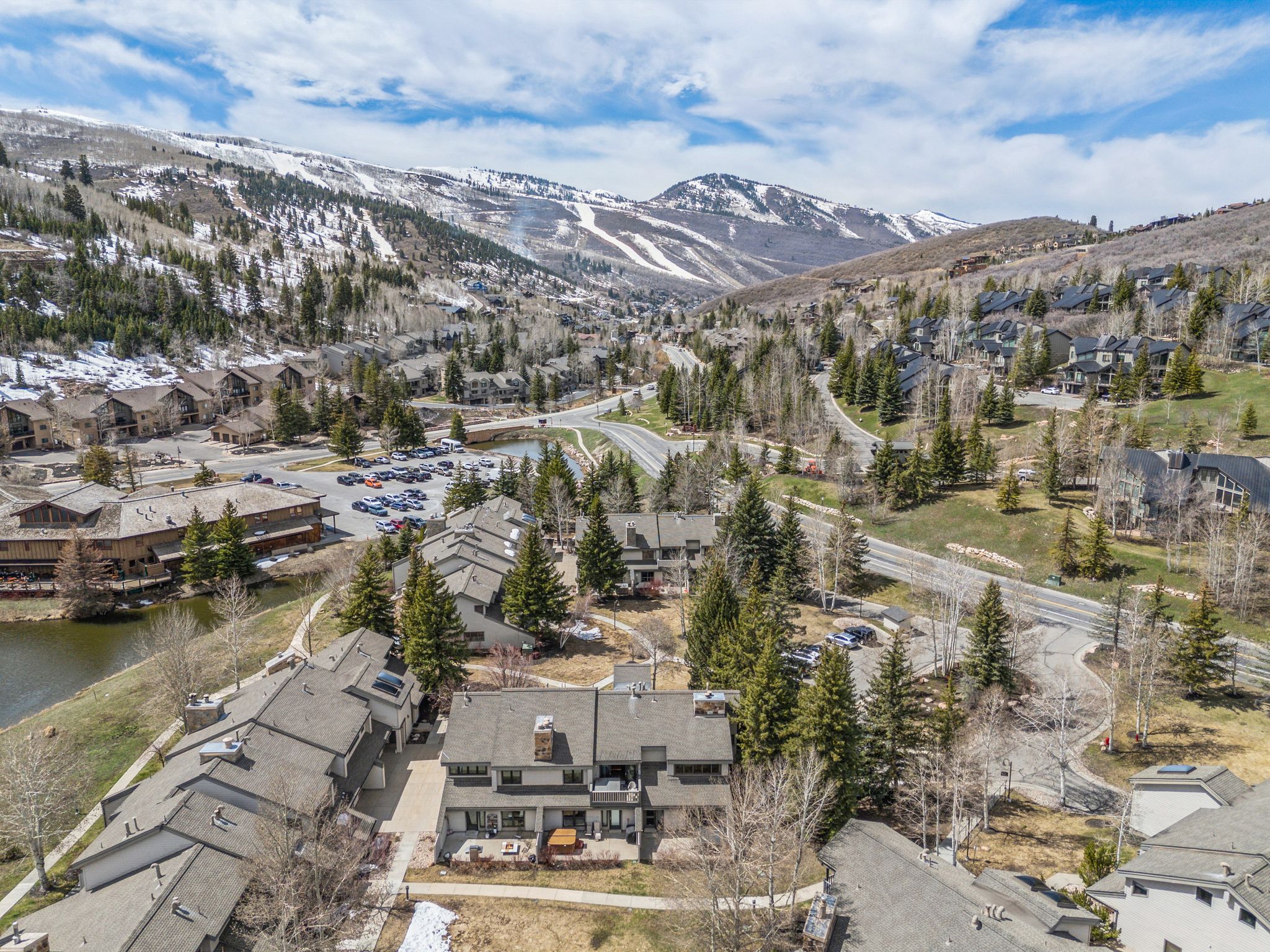 Mountain-side townhome featuring multiple decks and a neutral facade