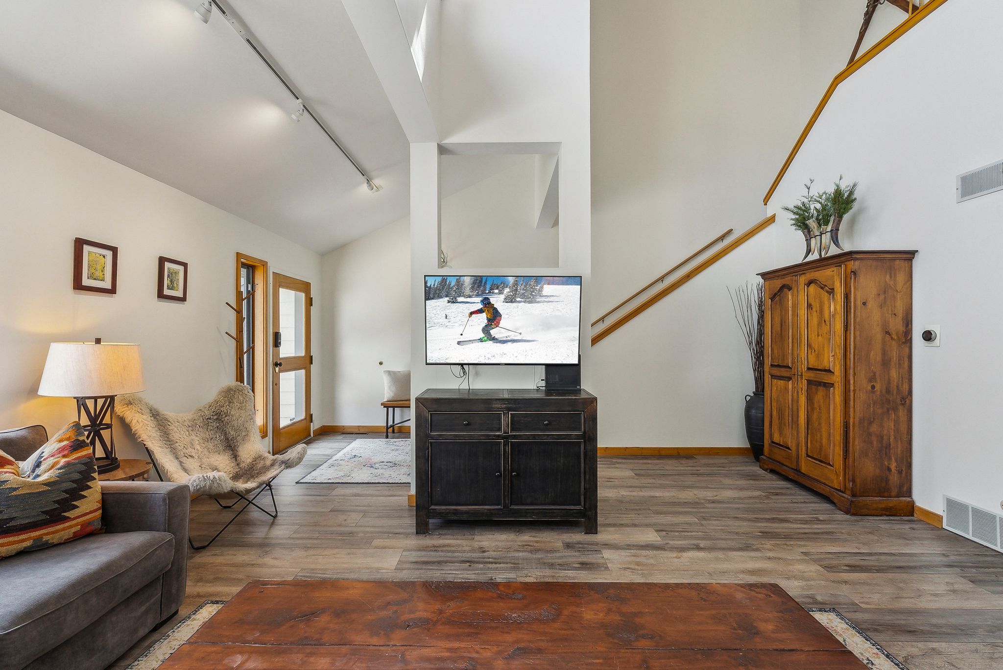 Vaulted white ceilings featuring track lighting