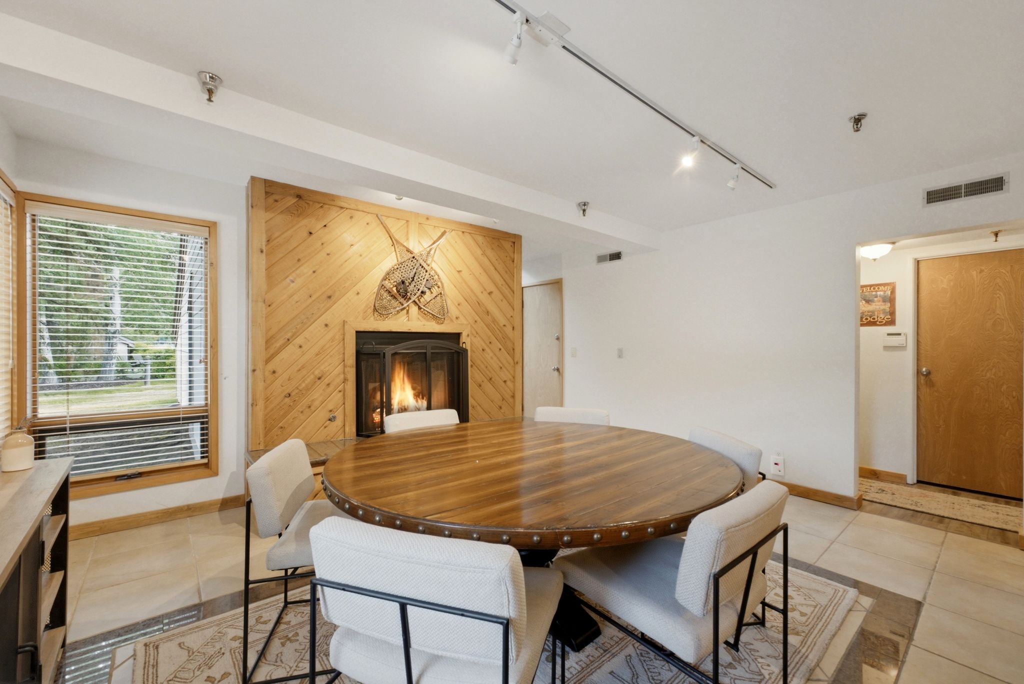 Focal fireplace featuring a wood-paneled surround and black firebox