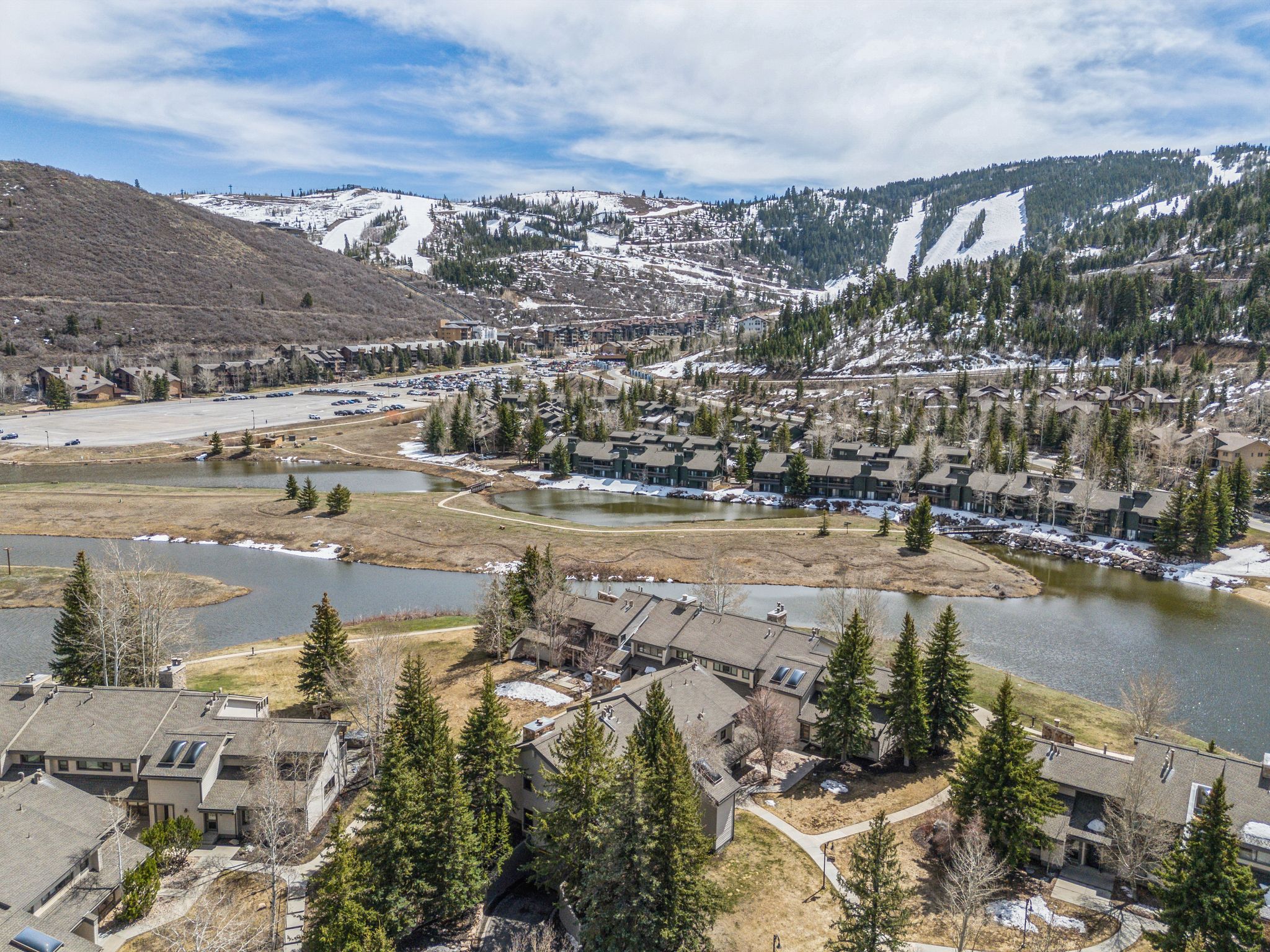 Aerial perspective showcasing multiple residential structures surrounded by natural landscaping