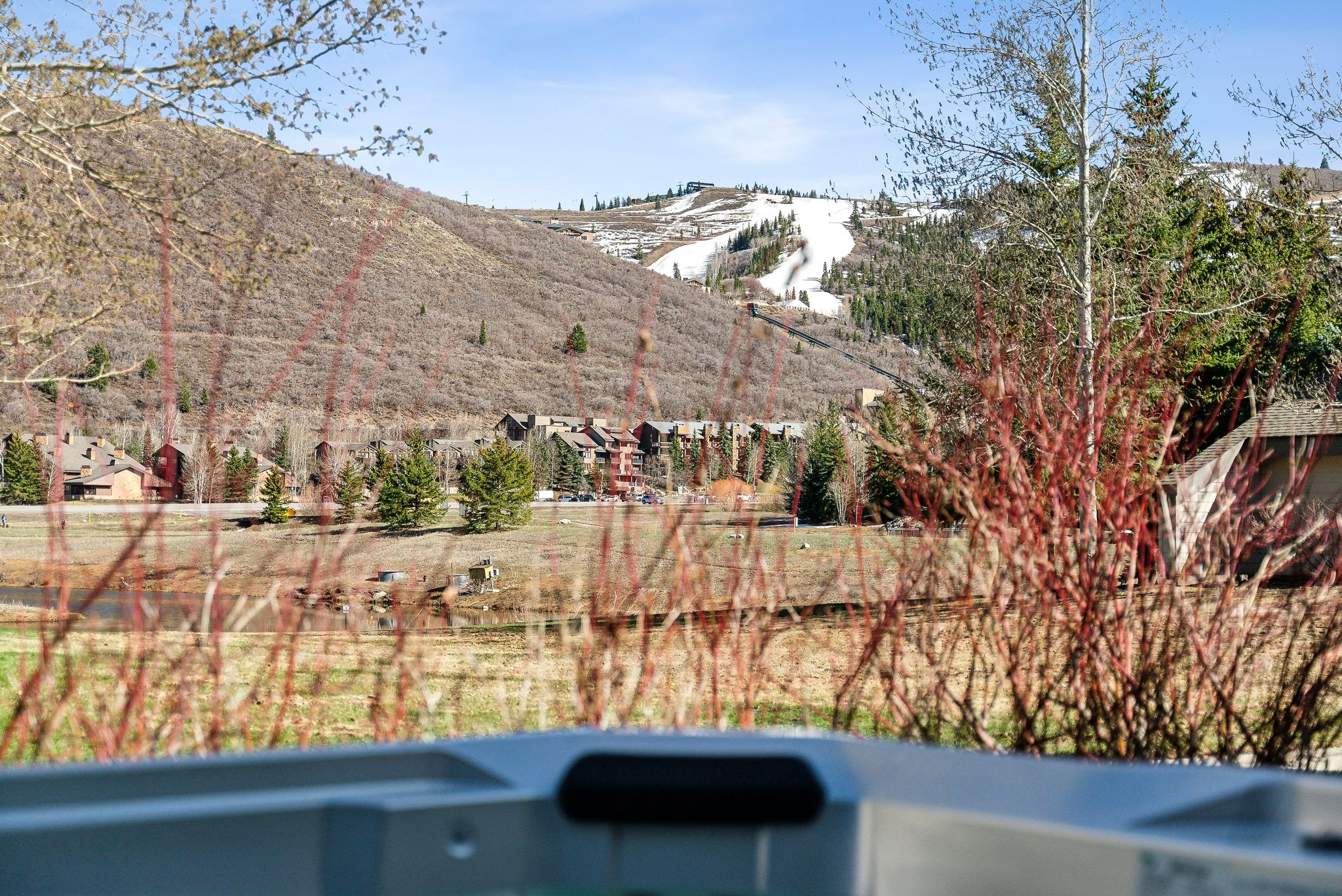 Outdoor spa with mountain and ski slope backdrop