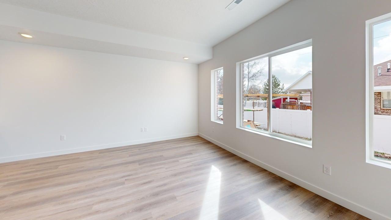 Open concept room featuring wood-finish flooring, recessed lighting, and multiple large windows with white trim