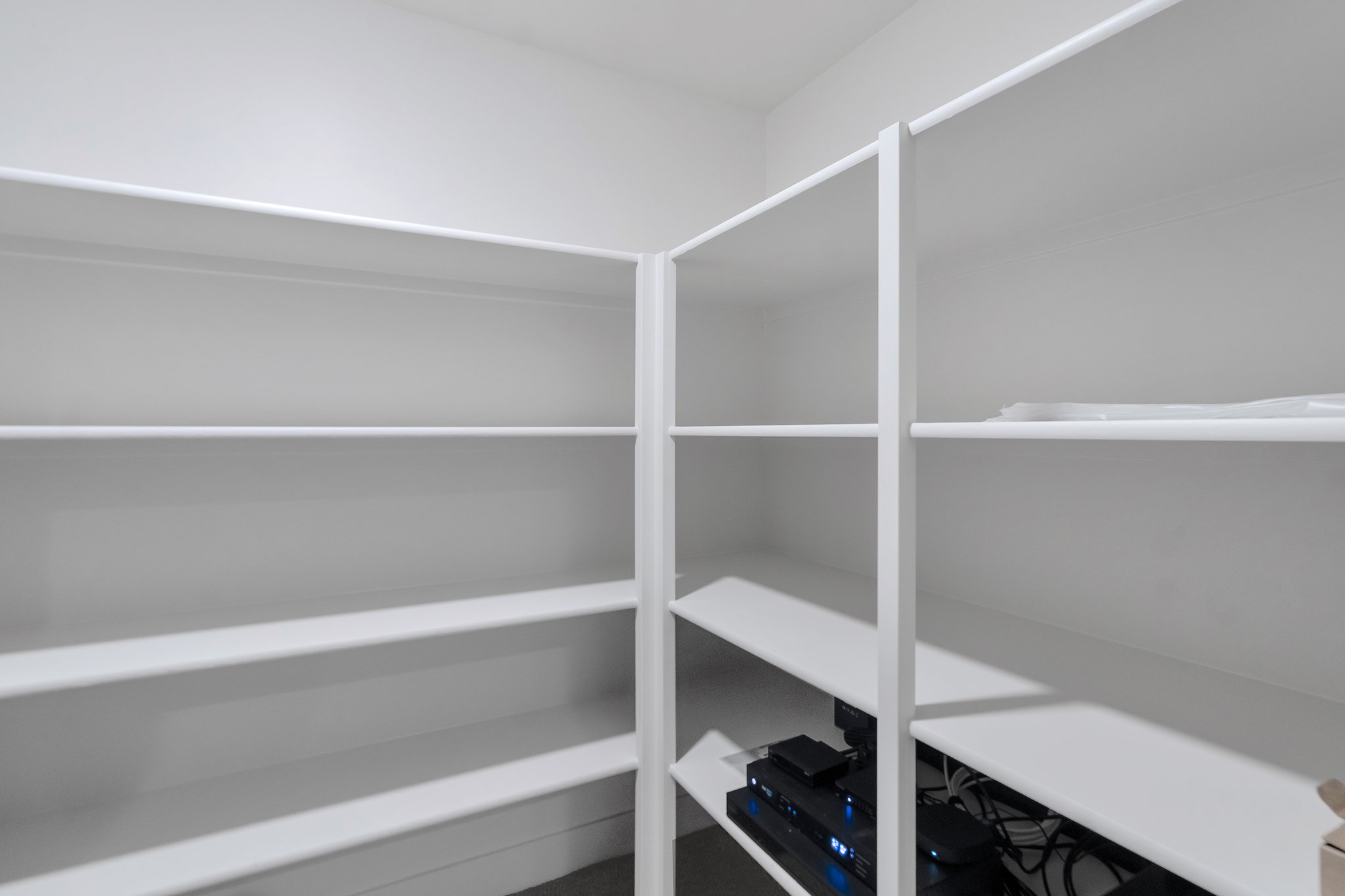 White built-in shelving providing extensive storage capacity